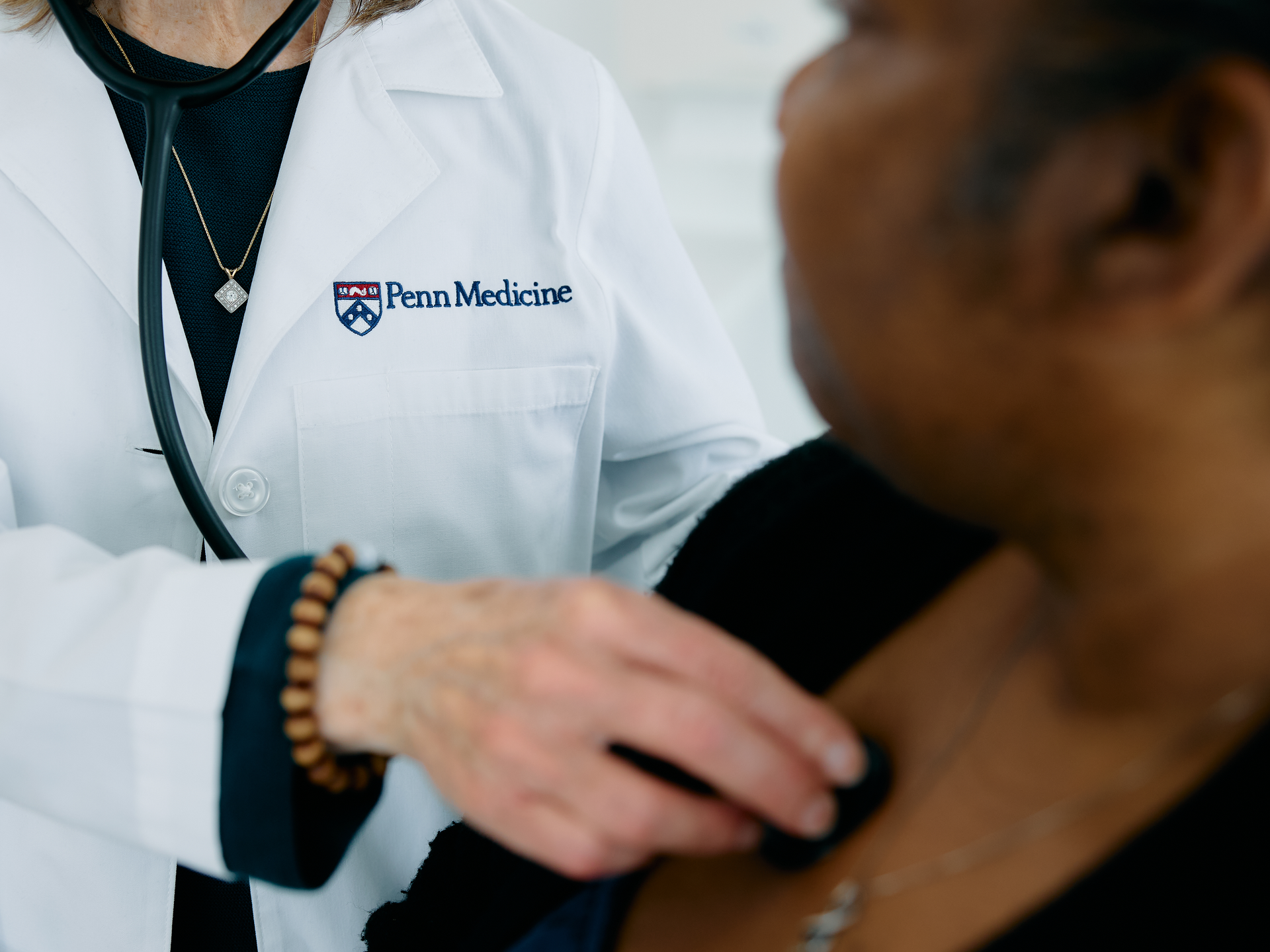 Cropped shot of Penn Medicine doctor listening to patients heart or lungs with stethoscope