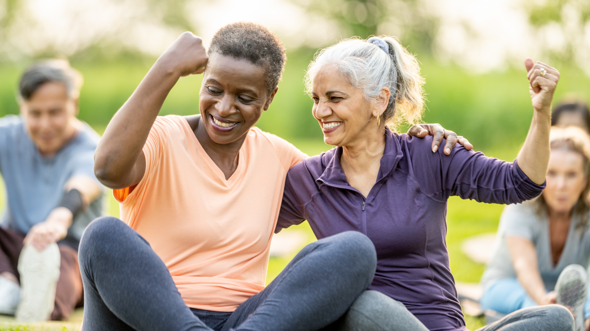 A group of senior individuals engaging in outdoor fitness activities, enjoying companionship and promoting health. The image captures smiles, togetherness, and active living in a beautiful natural setting.