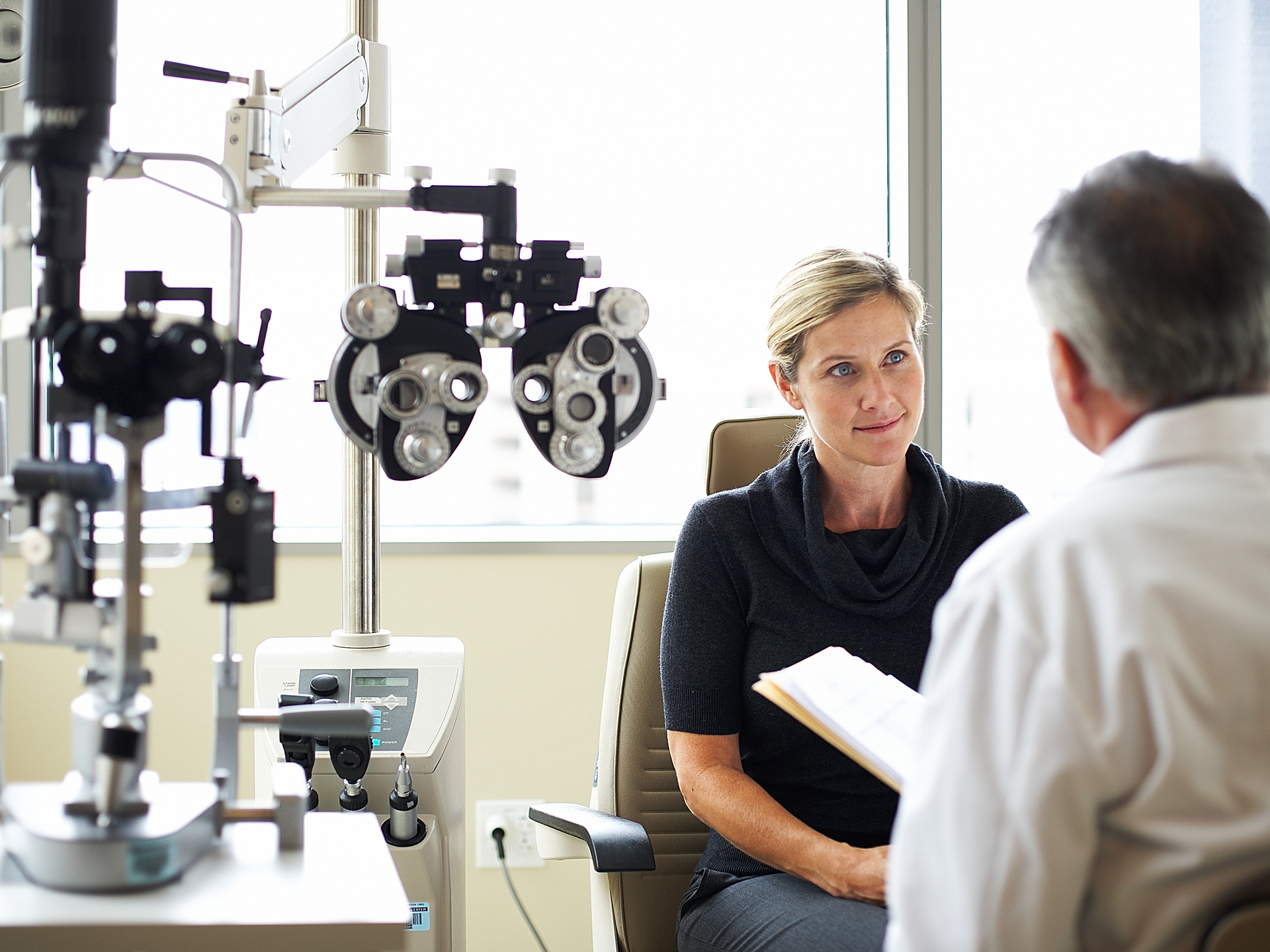 A woman listens to her opthamologist.