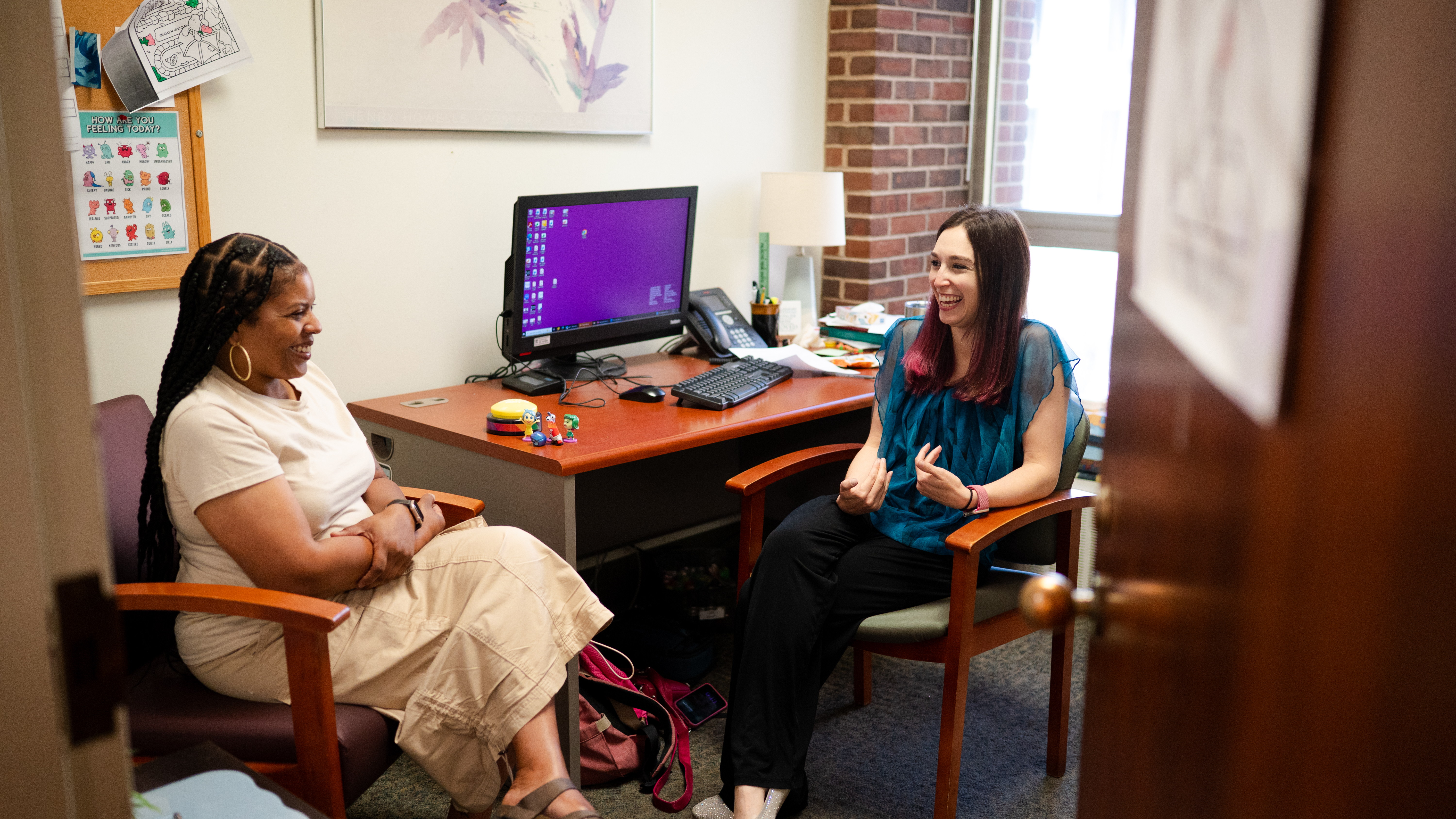 Marguerite Willis and Emily Becker-Haimes sitting in an office