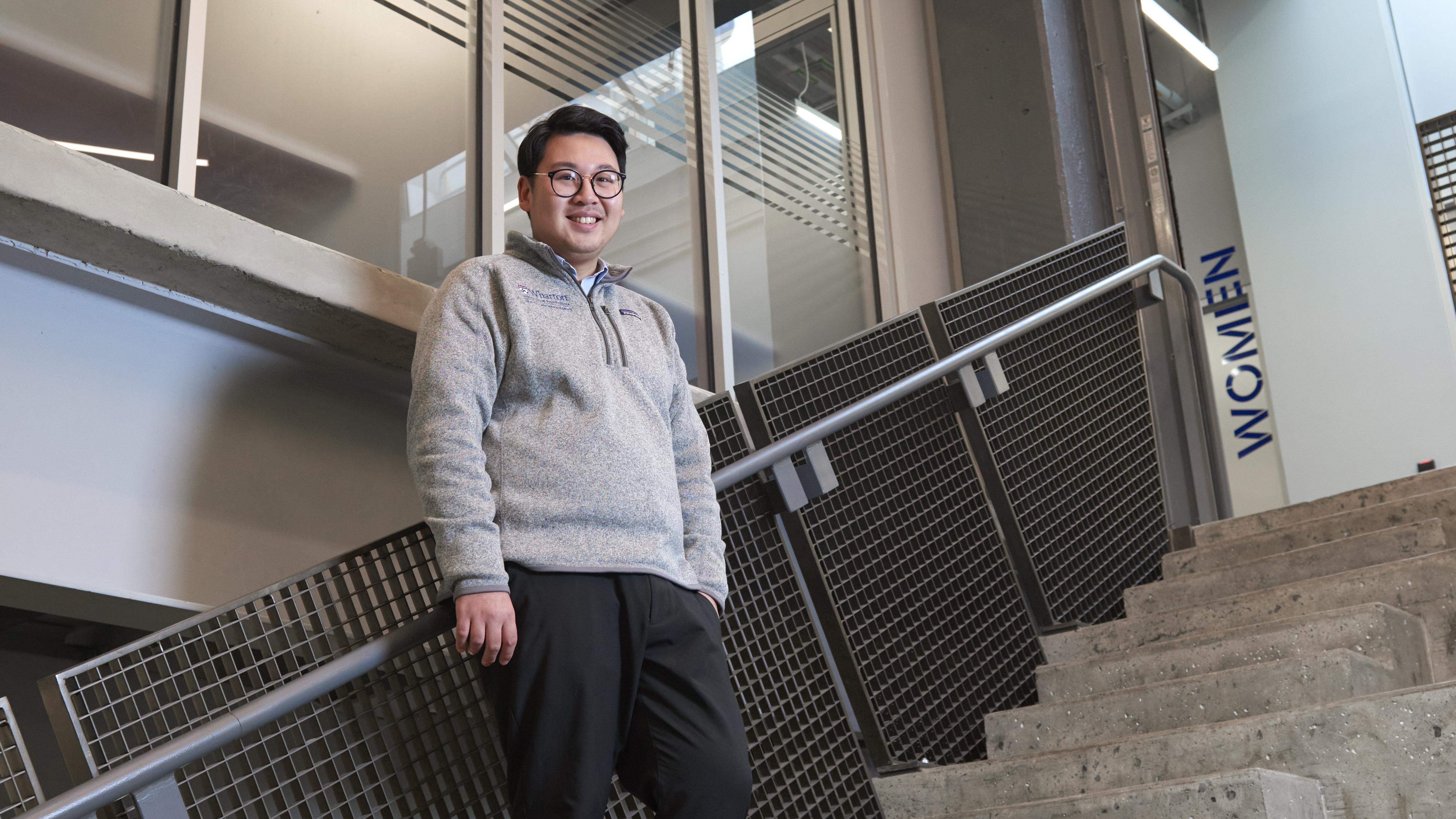 David Mui standing on a staircase