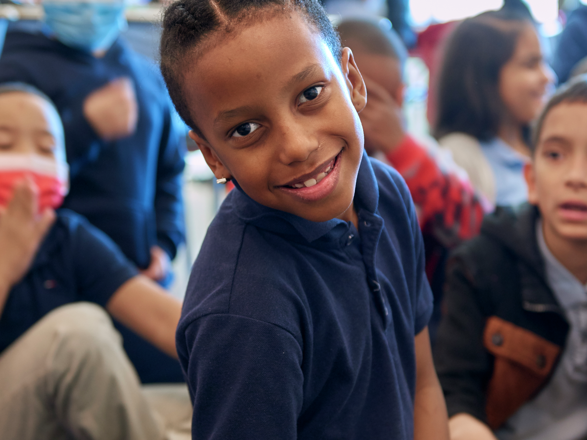 A boy looks confidently at the camera