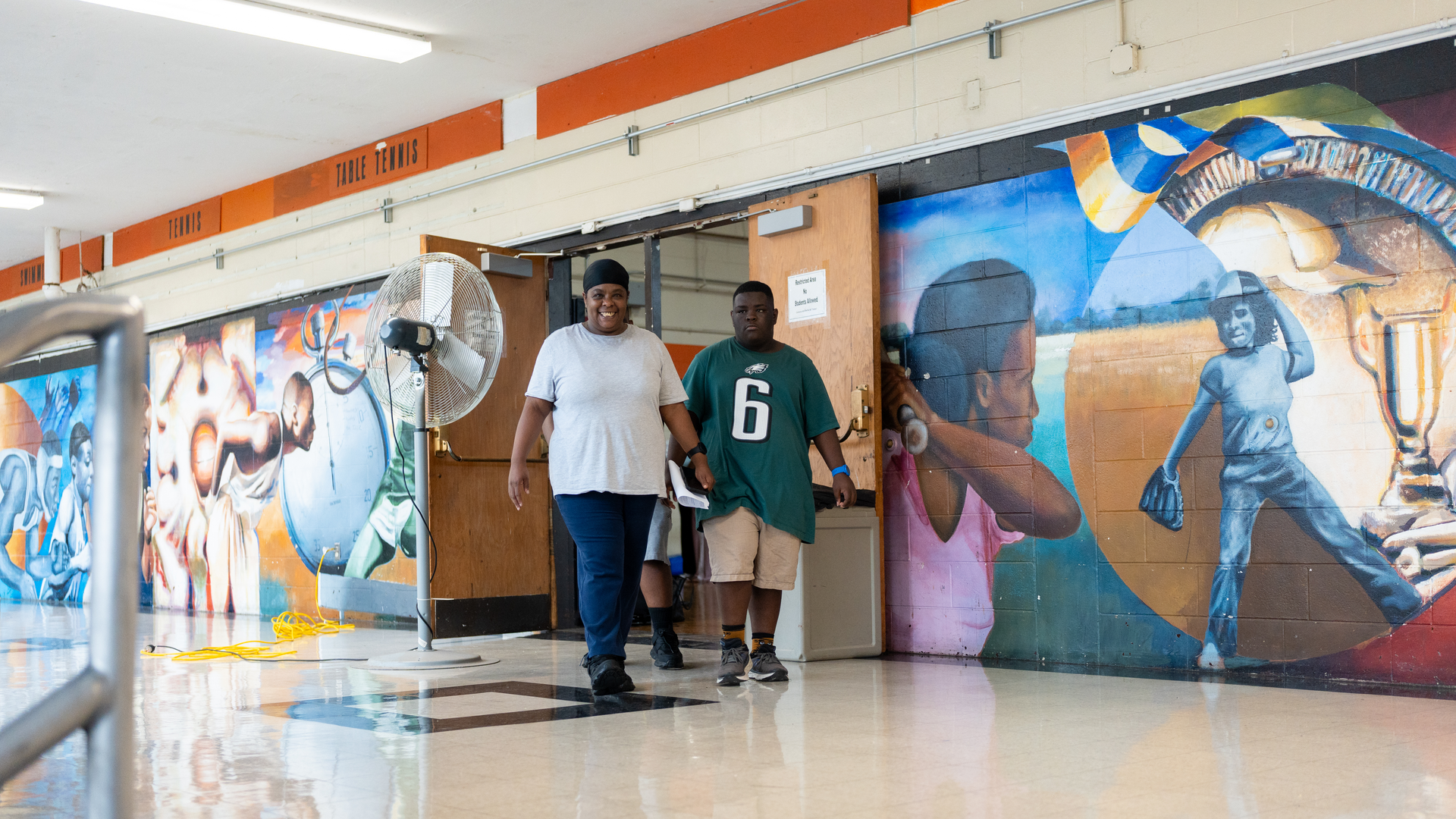 Jaisen Smith and his mom Brandy Hennie walking into a school gym