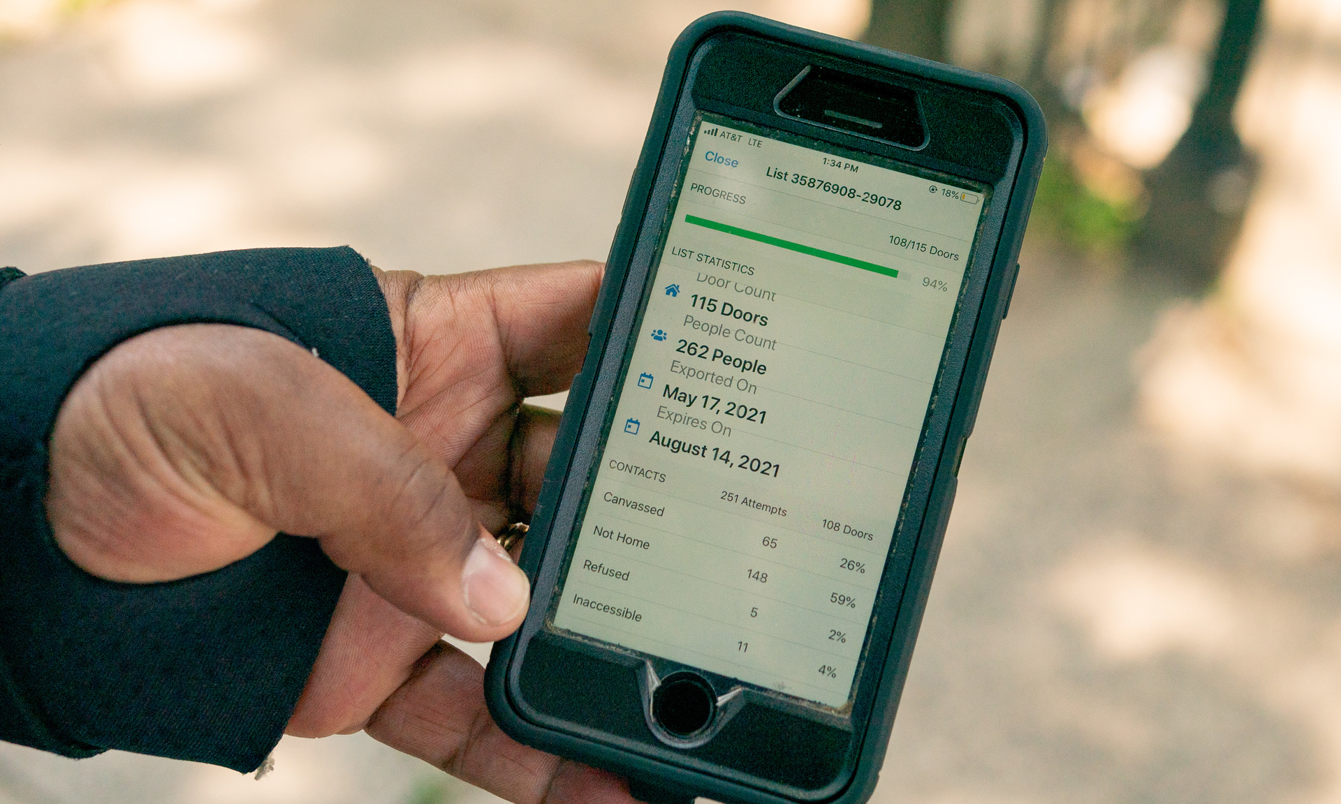 Close-up of a smartphone screen showing progress of a canvassing list from May 21, 2021