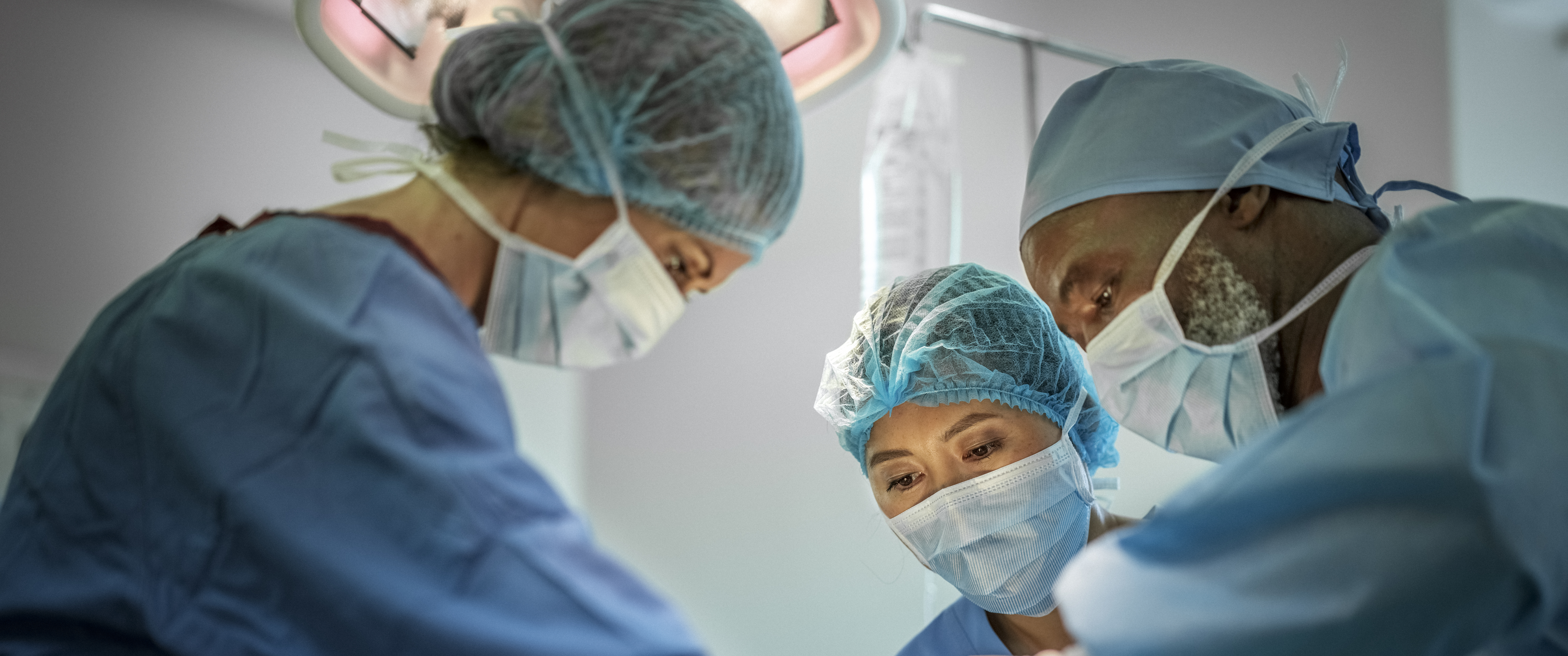 Diverse group of surgeons operating on patient