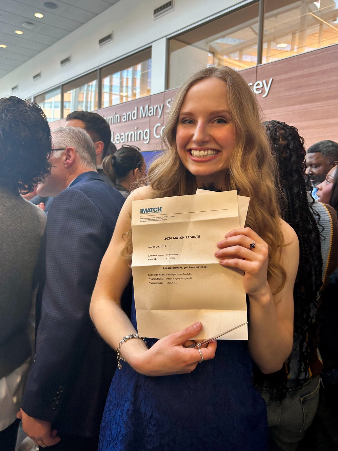 Holly Cordray holding a letter with her results for Match Day 2026