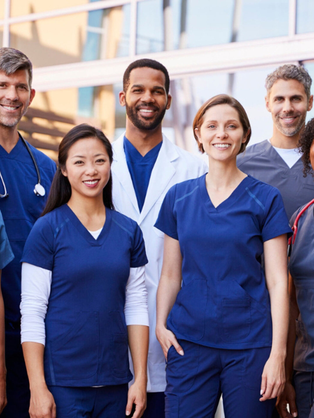 A group of Advanced Practice Providers is shown standing outside a hospital