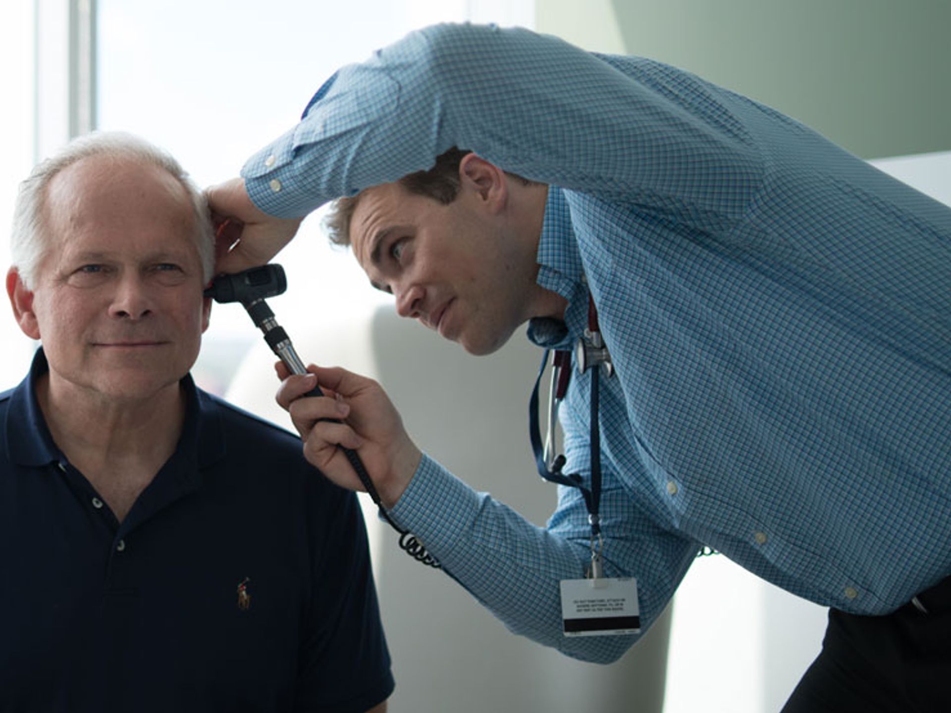 Doctor checking patient's ear