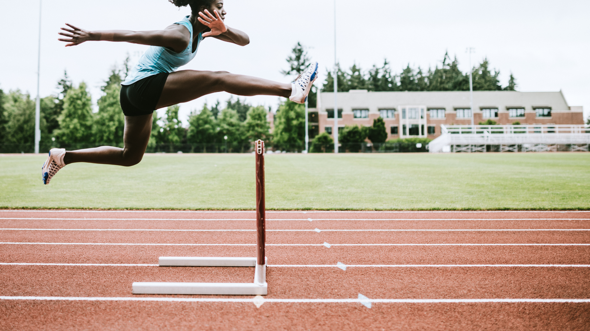 Female runner jumping over hurdle.jpg