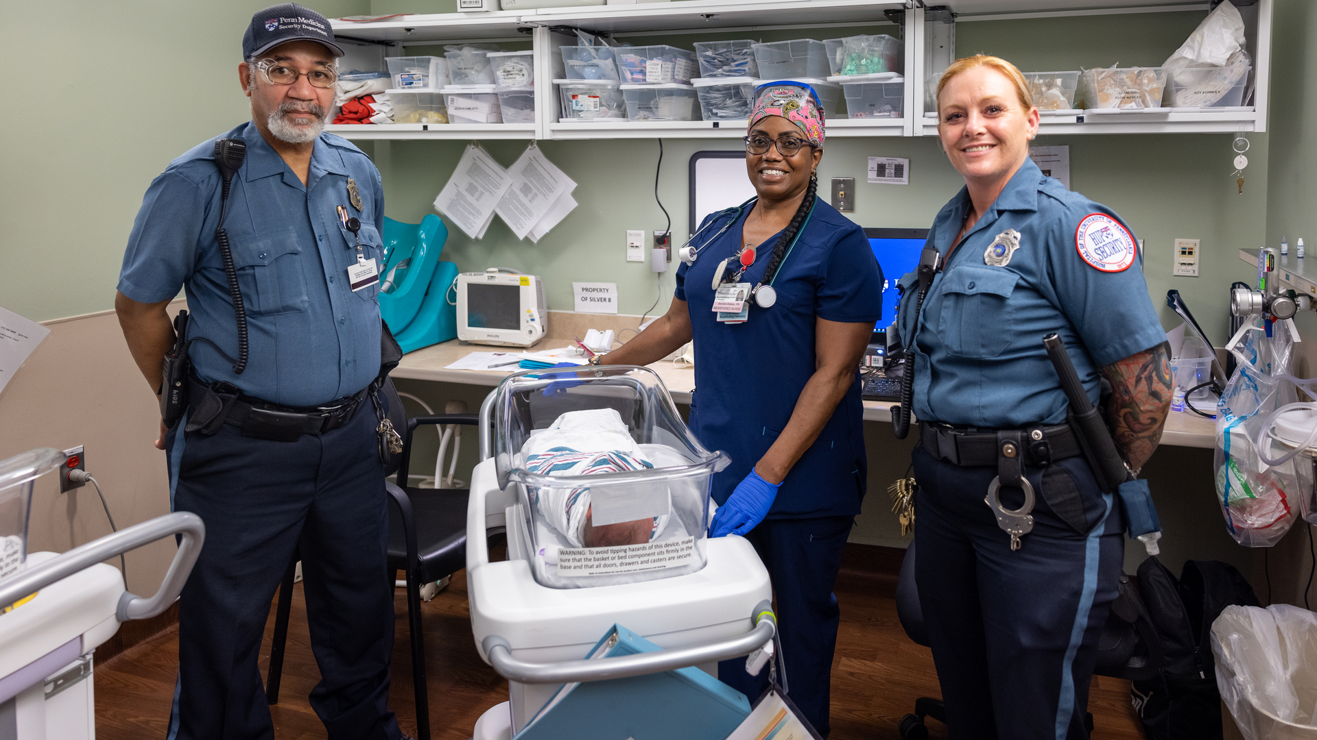 Two members of HUP security team pose with labor and delivery nurse and newborn 