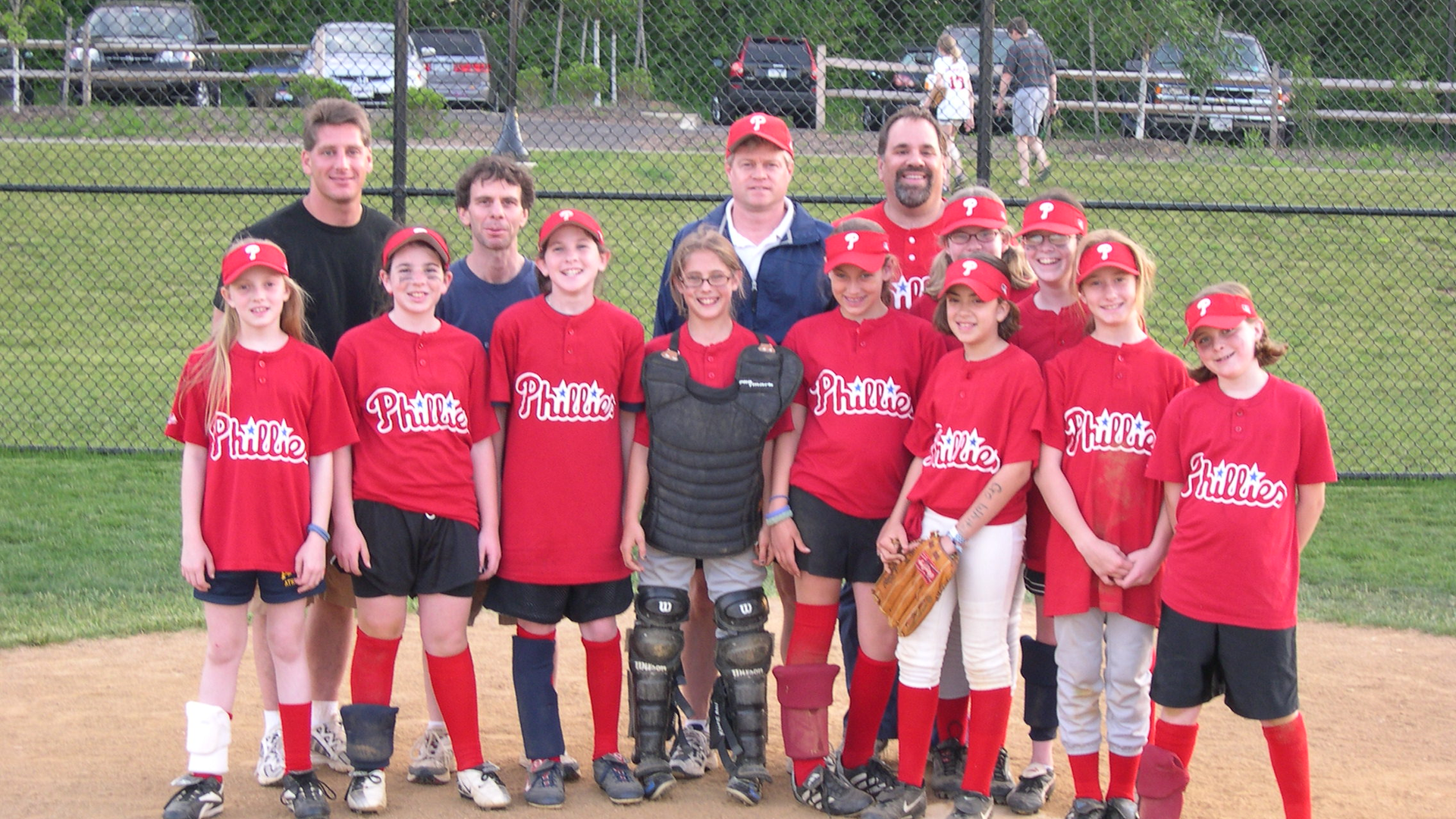 Mitch Schnall in a group photo with a youth baseball team in Phillies jersies 