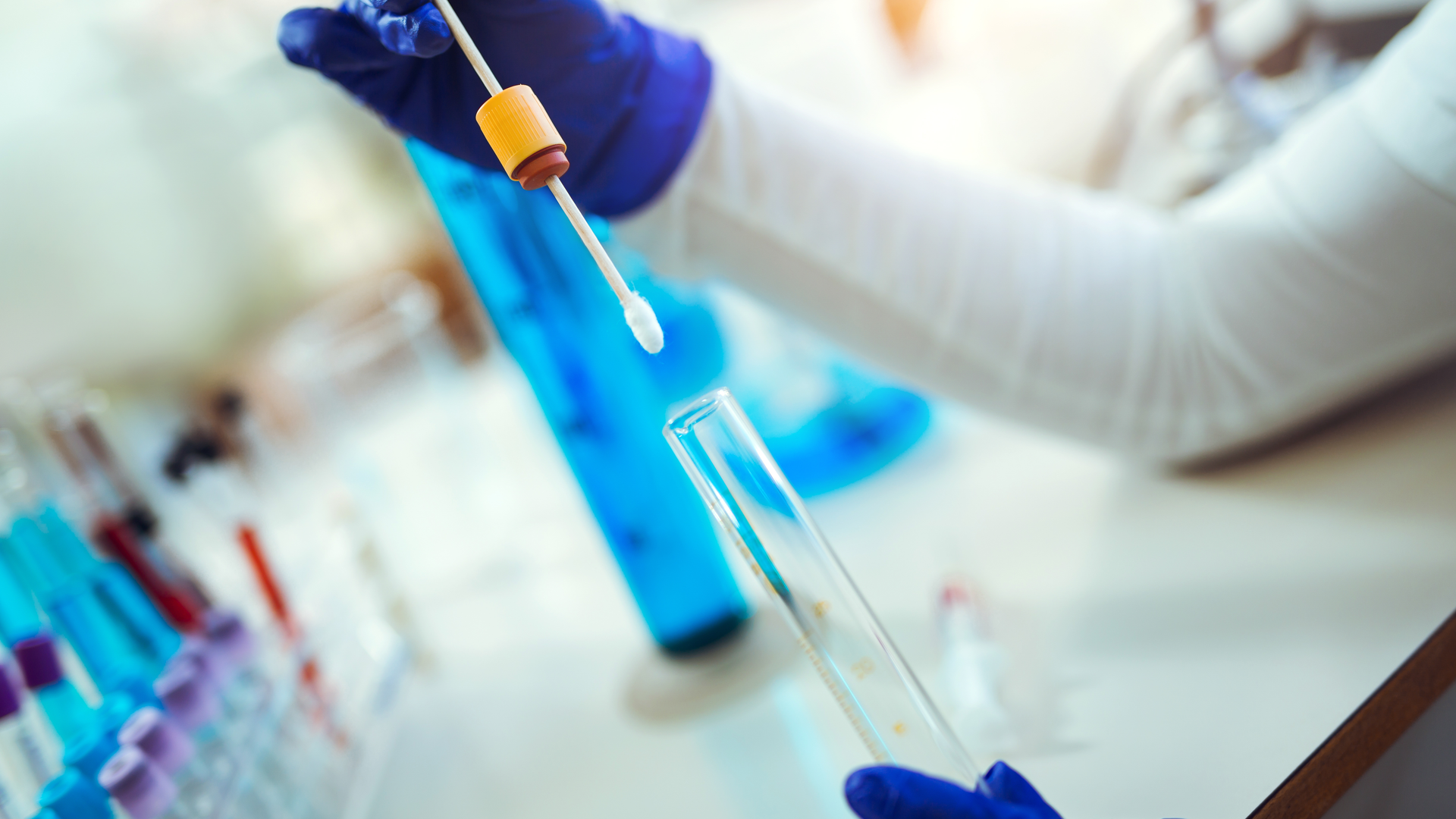 Female forensic technician collecting biological specimen in DNA