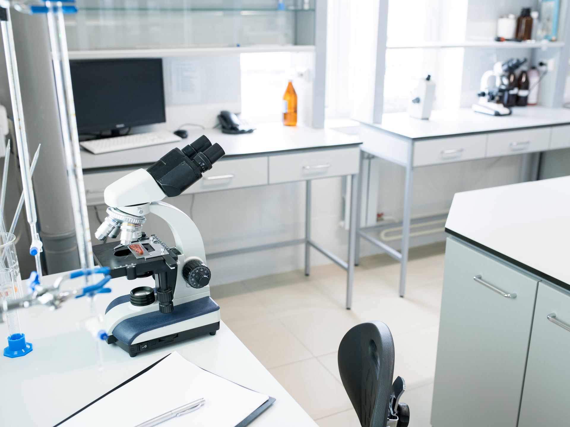 Microscope on table in empty laboratory