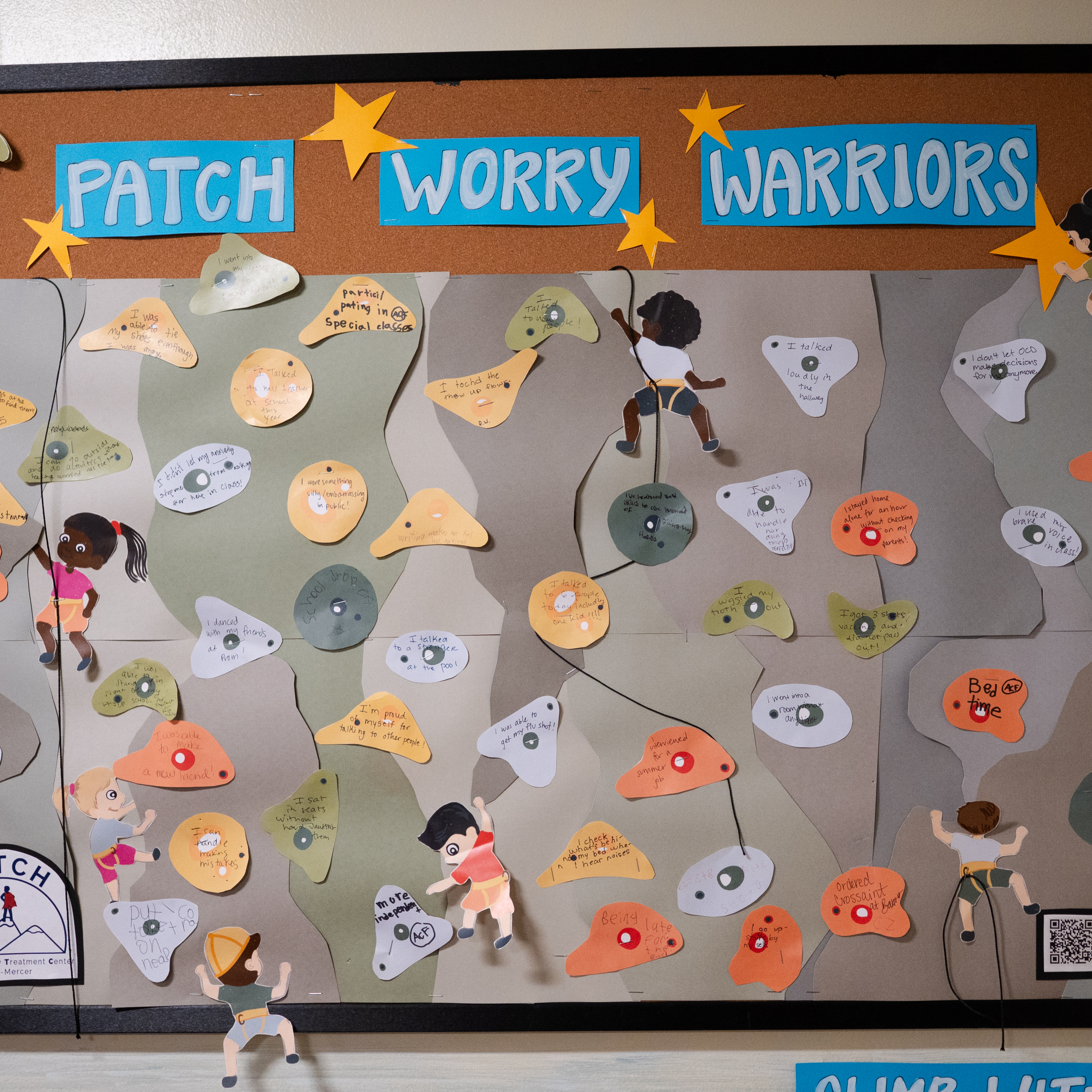 A poster board titled “PATCH Worry Warriors” with a rock-climbing theme and handwritten foothold-shape notes representing accomplishments
