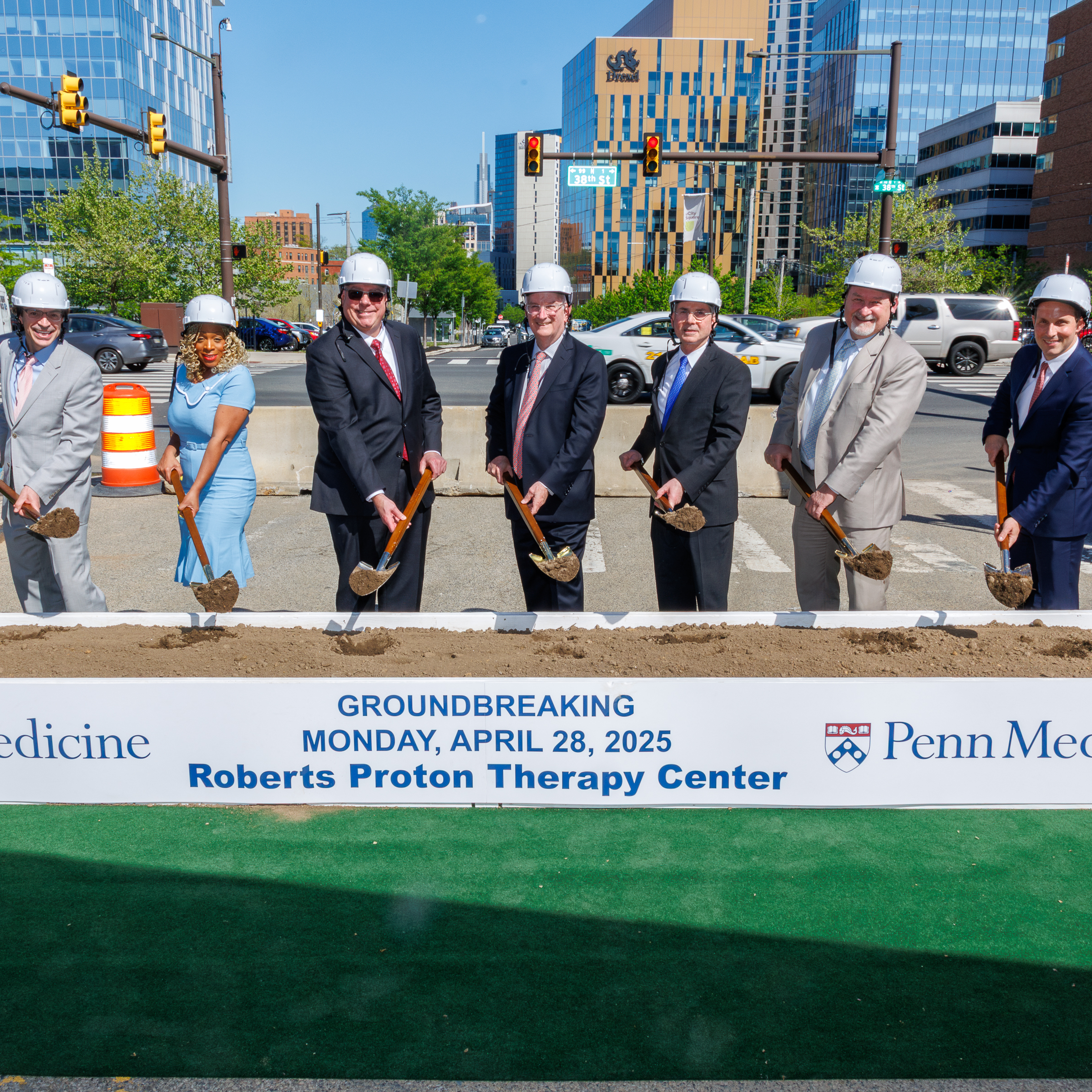 Leaders and public officials hold ceremonial shovels for the groundbreaking of the Roberts Proton Therapy Center at Penn Presbyterian