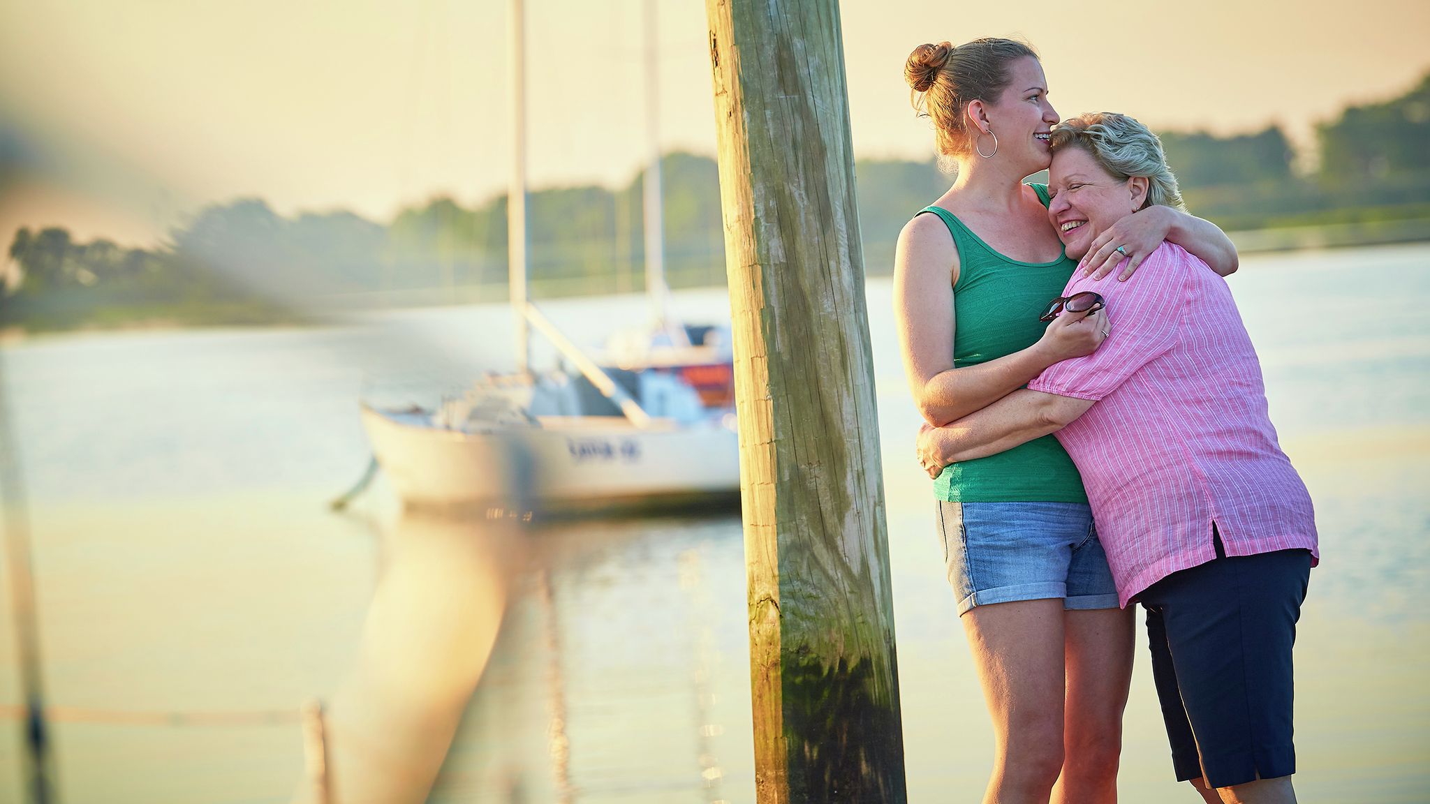 Living liver donor and recipient, mother daughter embrace by the bay