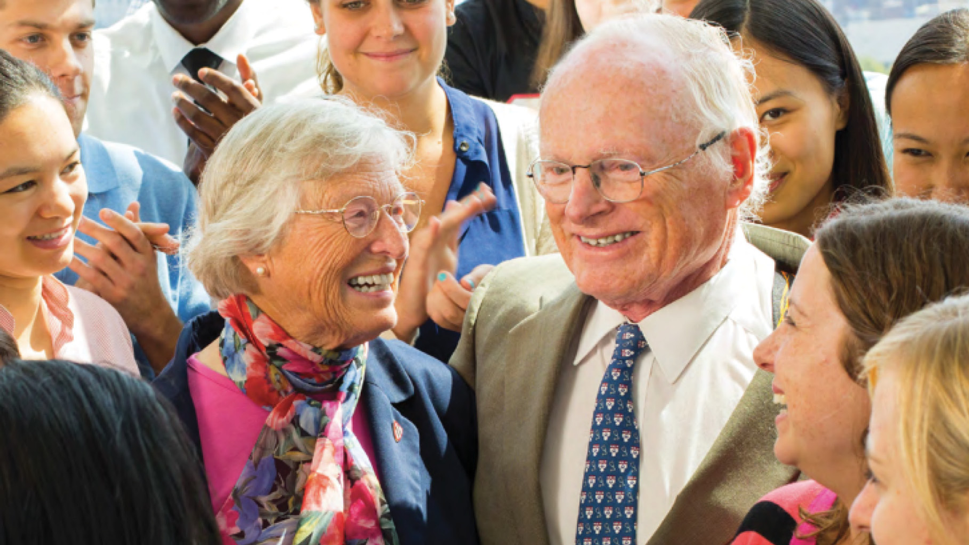 Anne and Walter Gamble, smiling, surrounded by medical students
