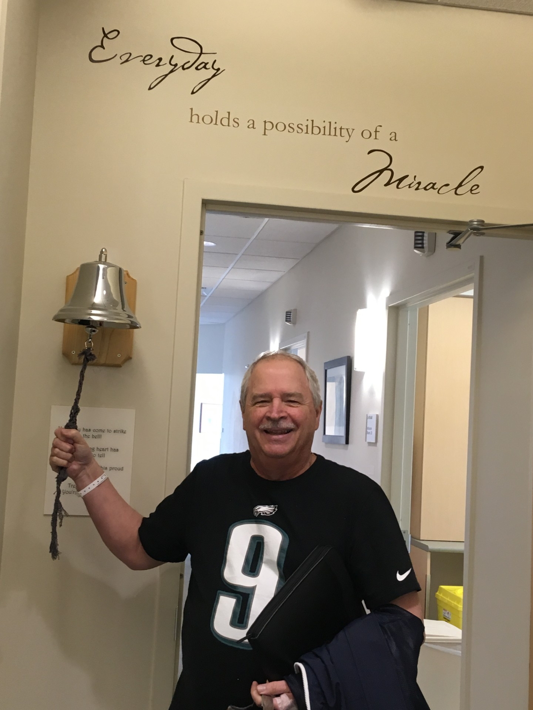 A patient rings the bell marking the end of proton radiation treatment