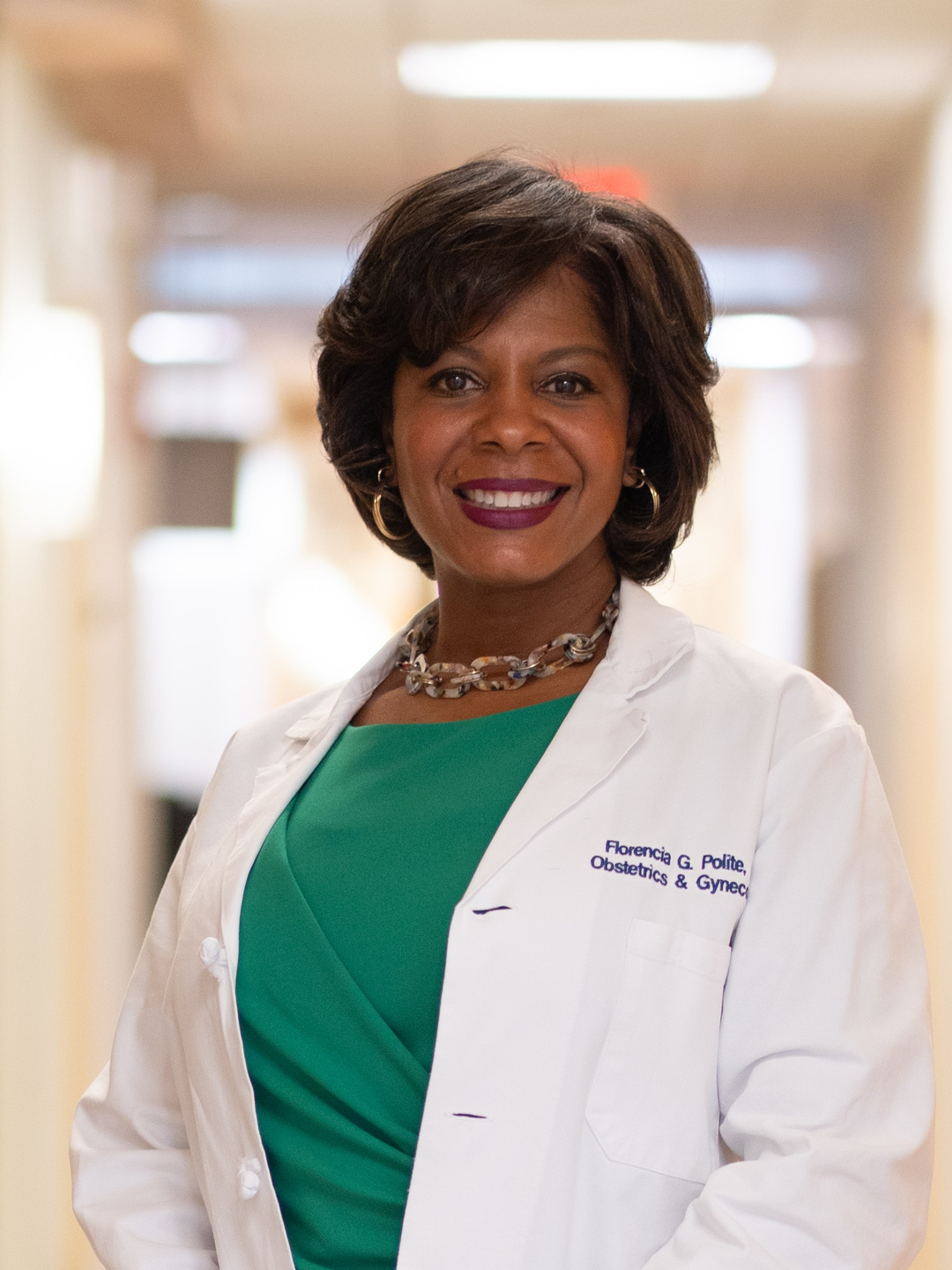 Florencia Polite in a white coat in a hospital hallway