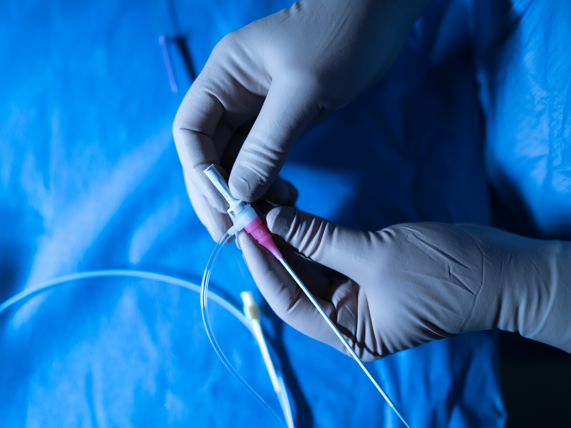 Catheter being held by gloved hands