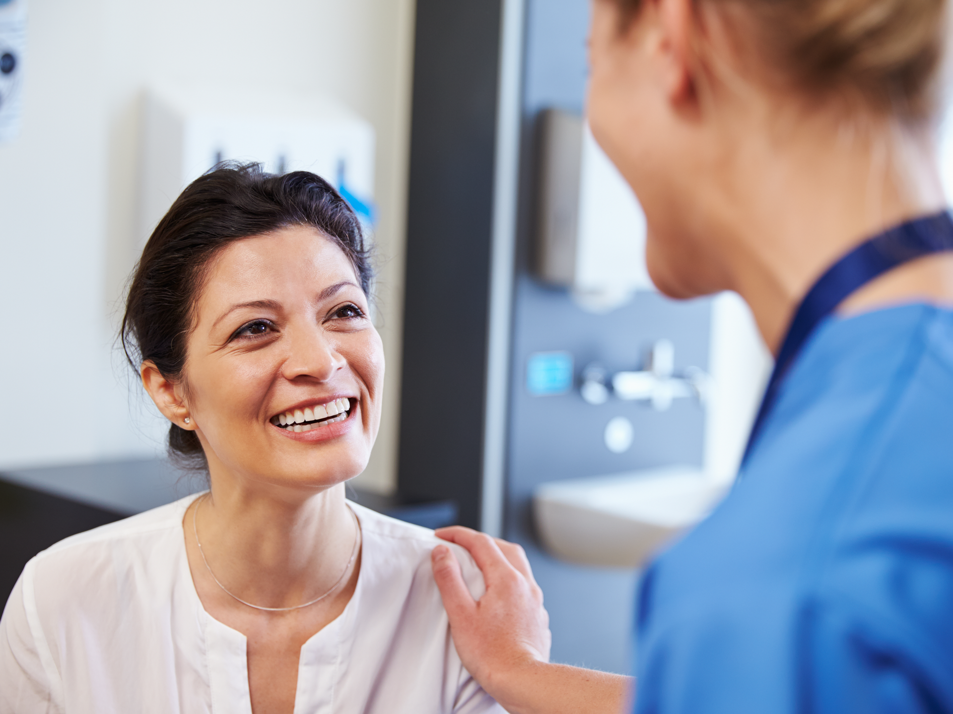  Female patient being reassured by doctor In doctor's office