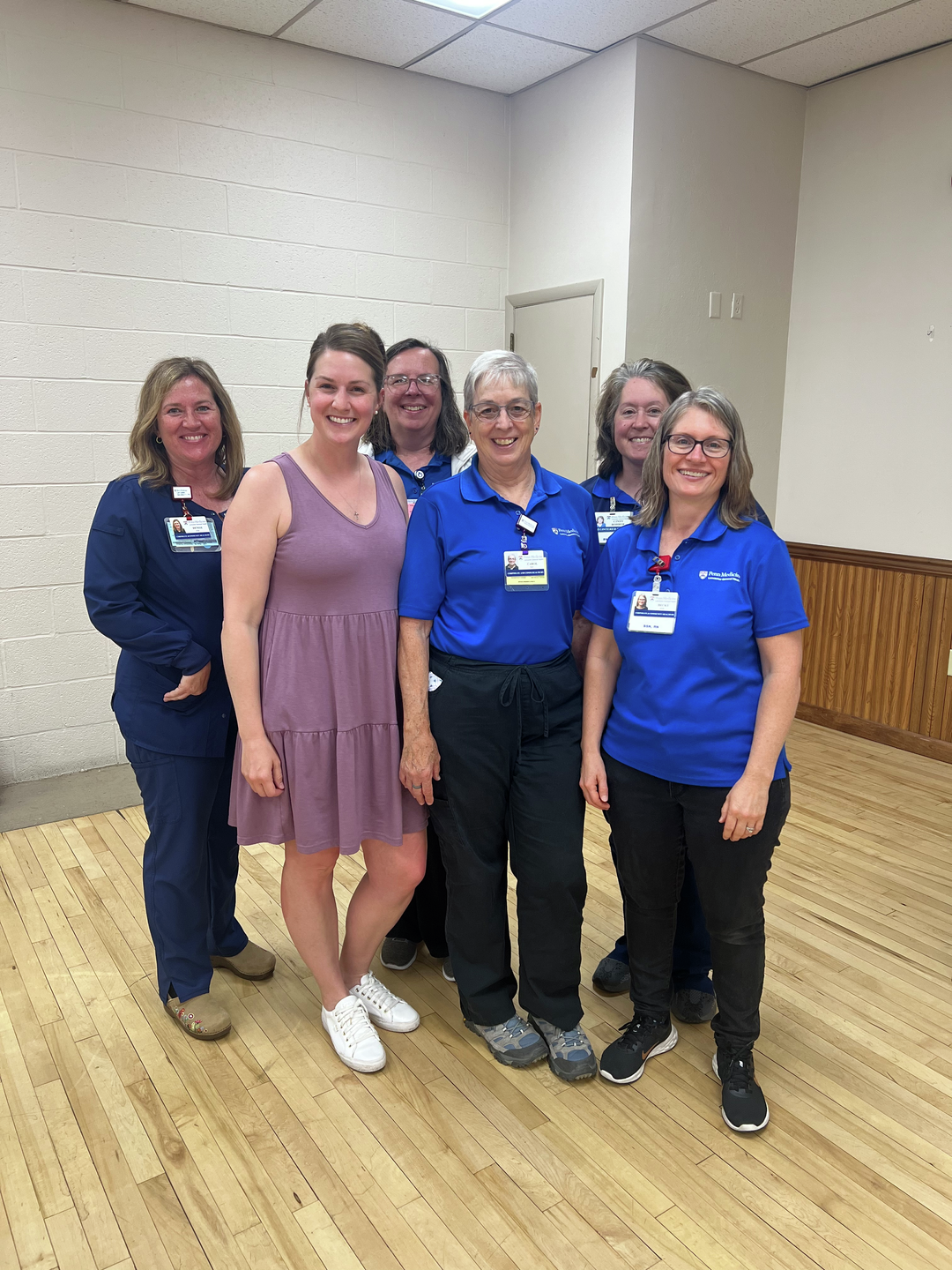 A group shot of ChildProtect nurses gathering and smiling at the Witmer Fire Hall vaccine clinic.