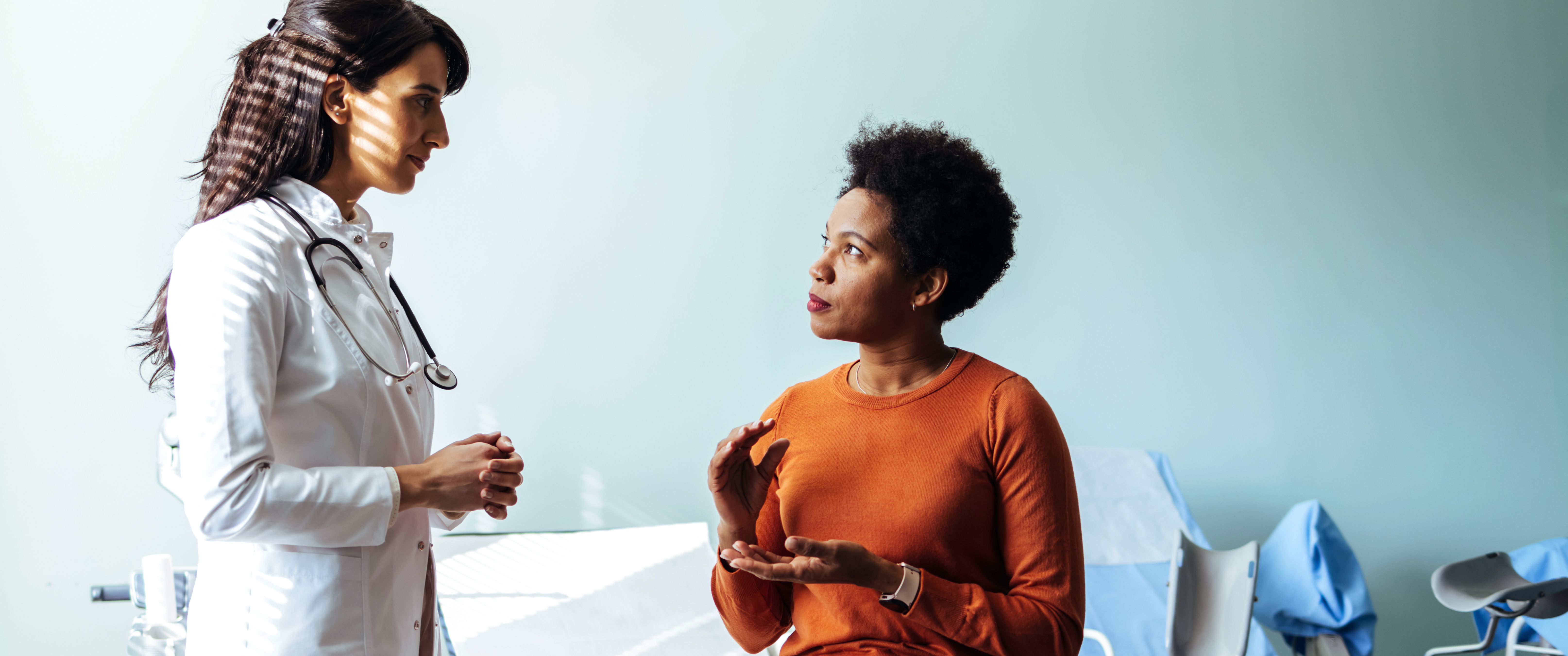 Woman talking to doctor