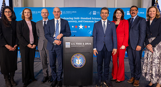 A group standing around a podium for a FDA announcement