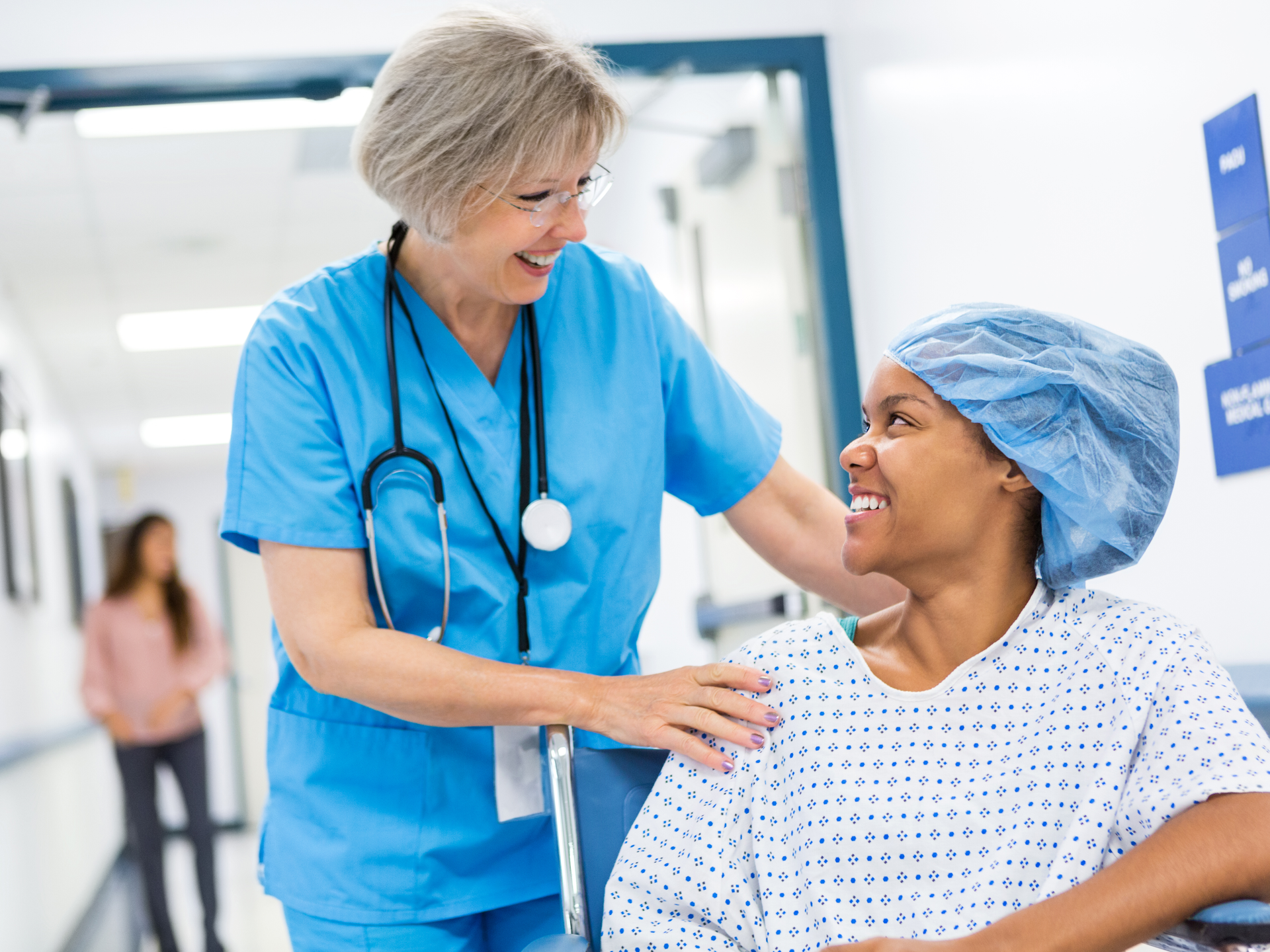 Nurse taking patient to recovery after outpatient surgical procedure