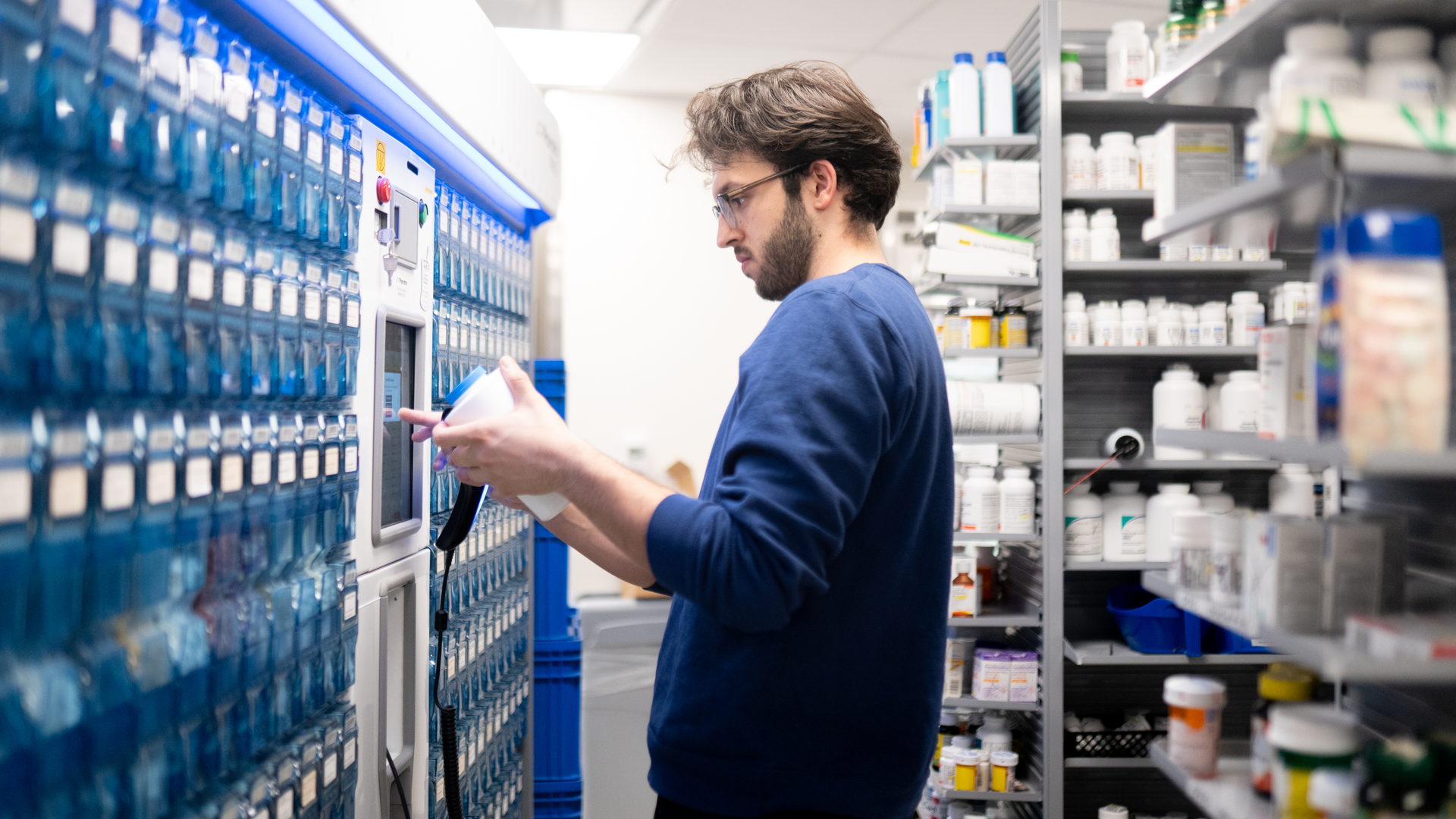 A pharmacist enters instructions into a dispensing machine at the retail pharmacy in Penn Presbyterian Medical Center