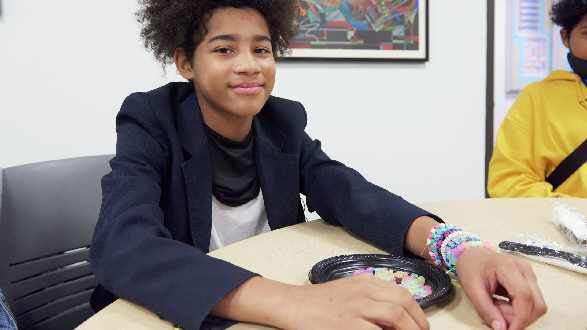 A teenage boy smiles at the camera