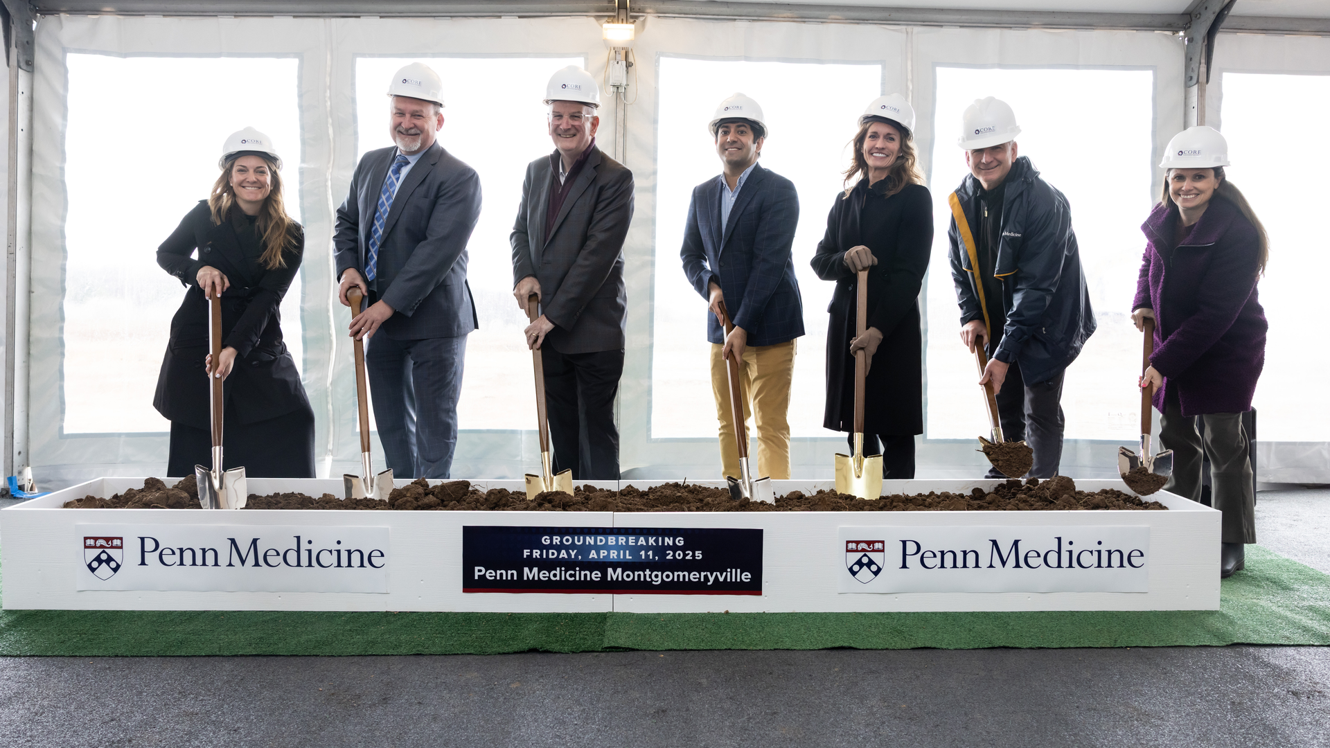 A group of leaders wears helmets and holds ceremonial shovels to "break ground" for Penn Medicine Montgomeryville
