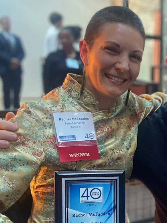 Rachel McFadden holding a Philadelphia Business Journal plaque at an award ceremony next to James Sherman