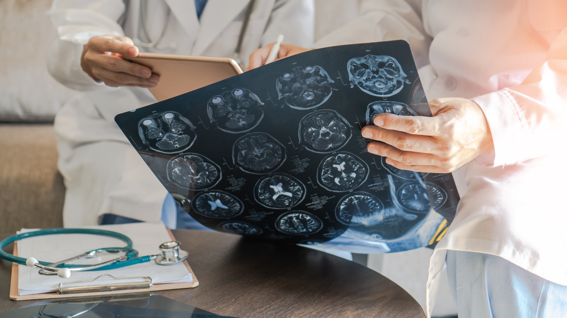 professional brain and neurological surgeon with digital tablet working in hospital clinic discussion