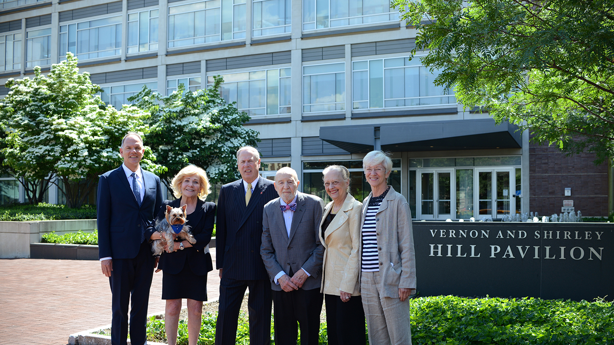 Group photo of Penn officials and the Hills on the Penn campus