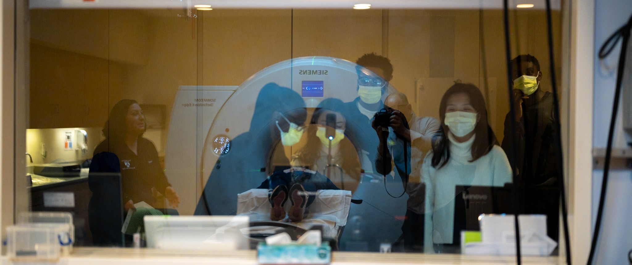 Students set up a camera to film radiation therapist Angela Natale making a mask for a patient
