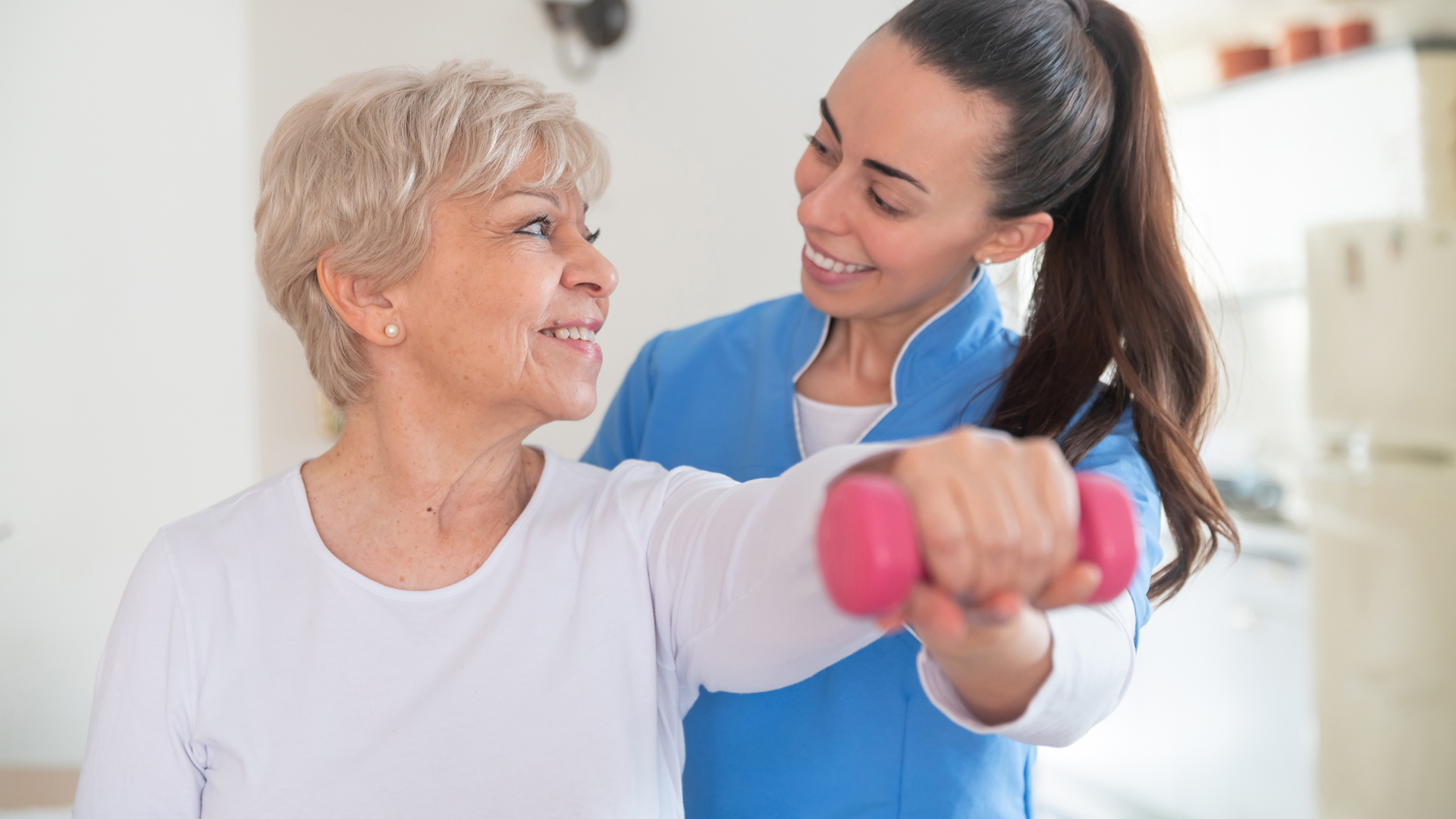 A physical therapist helping a senior woman with her routine.