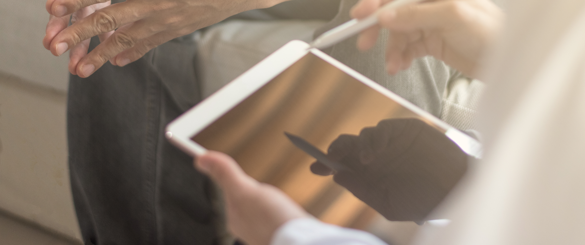Doctor holding iPad in front of patient