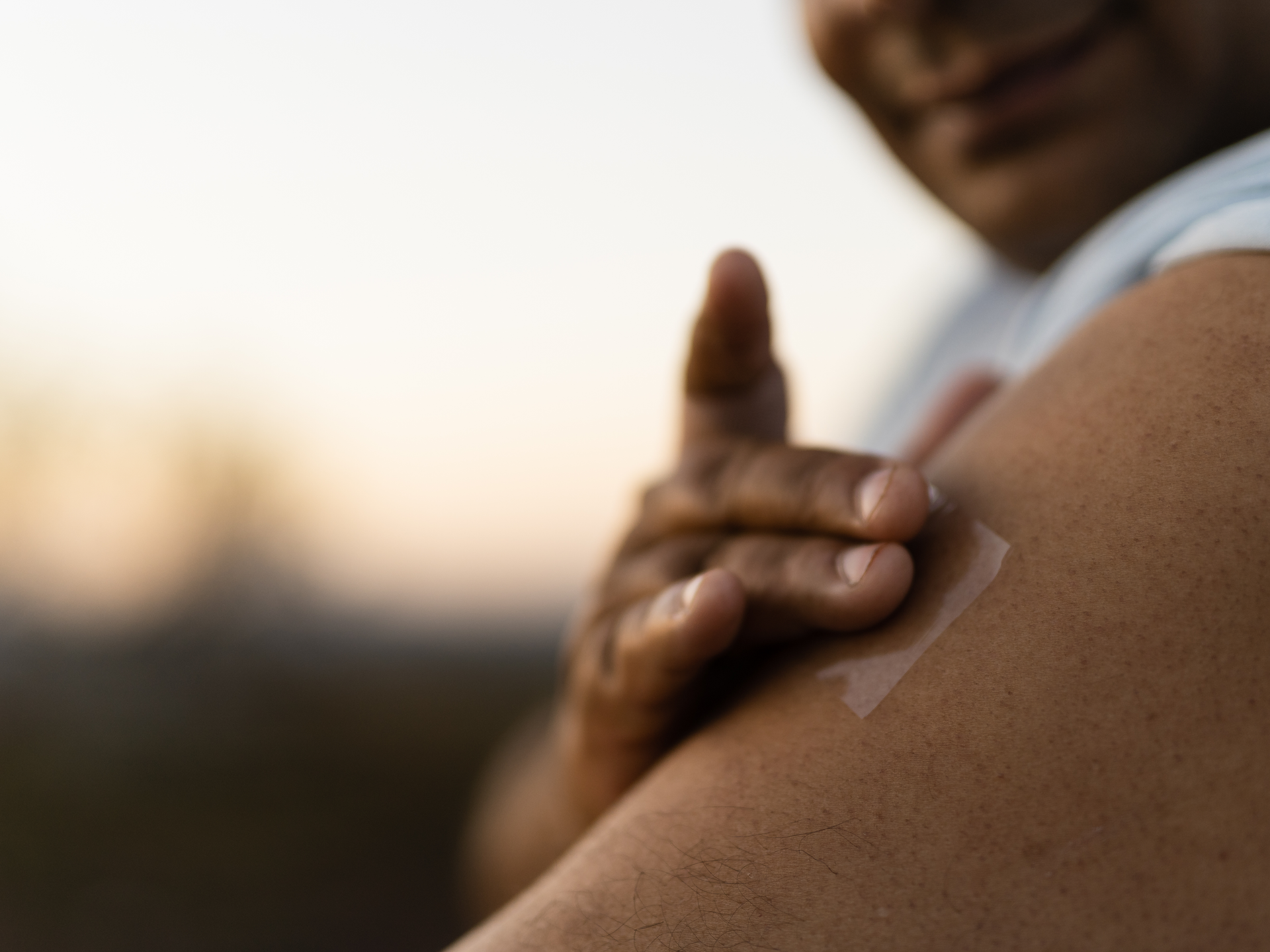 Man putting nicotine patch on his arm