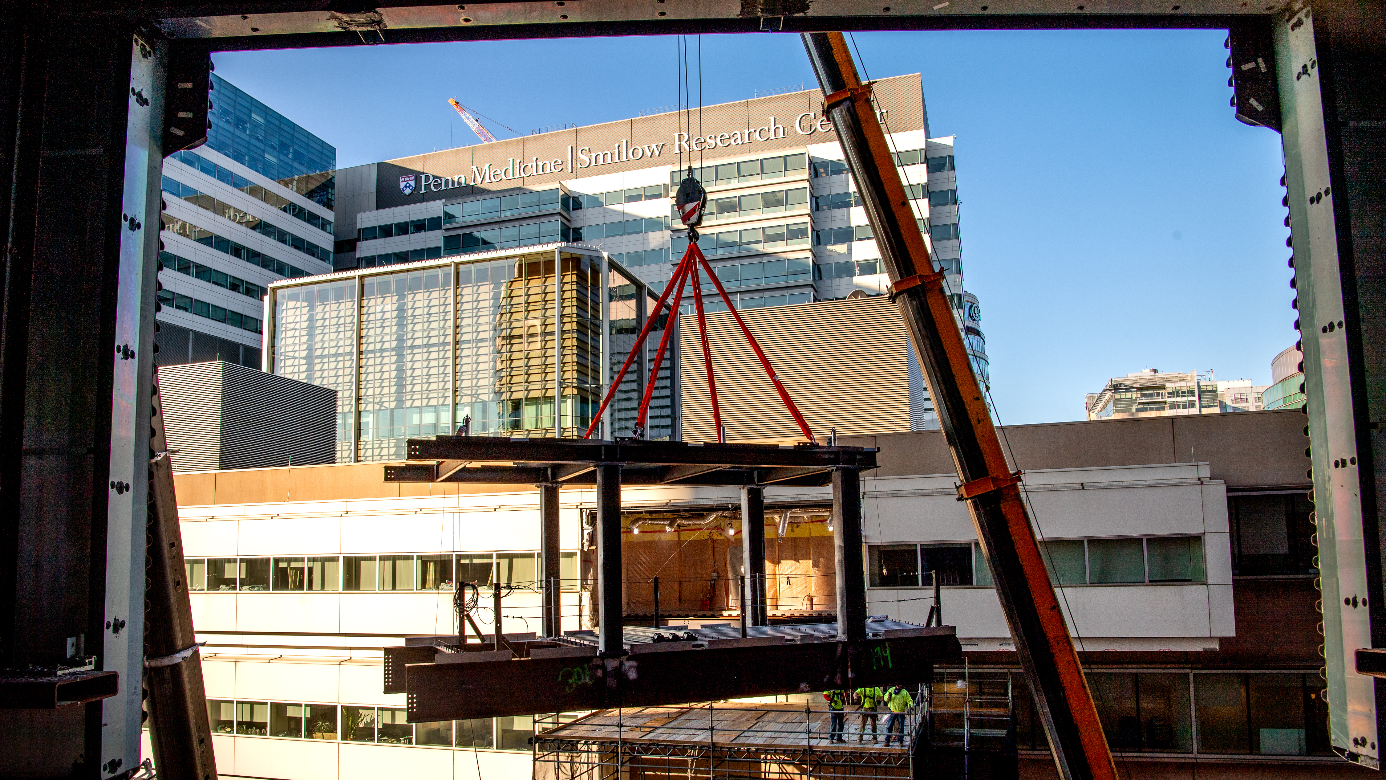  A view from inside the Clifton Center during its construction, showing the Smilow and Perelman Centers and the structural beams hoisted that will become the bridge connecting to them.