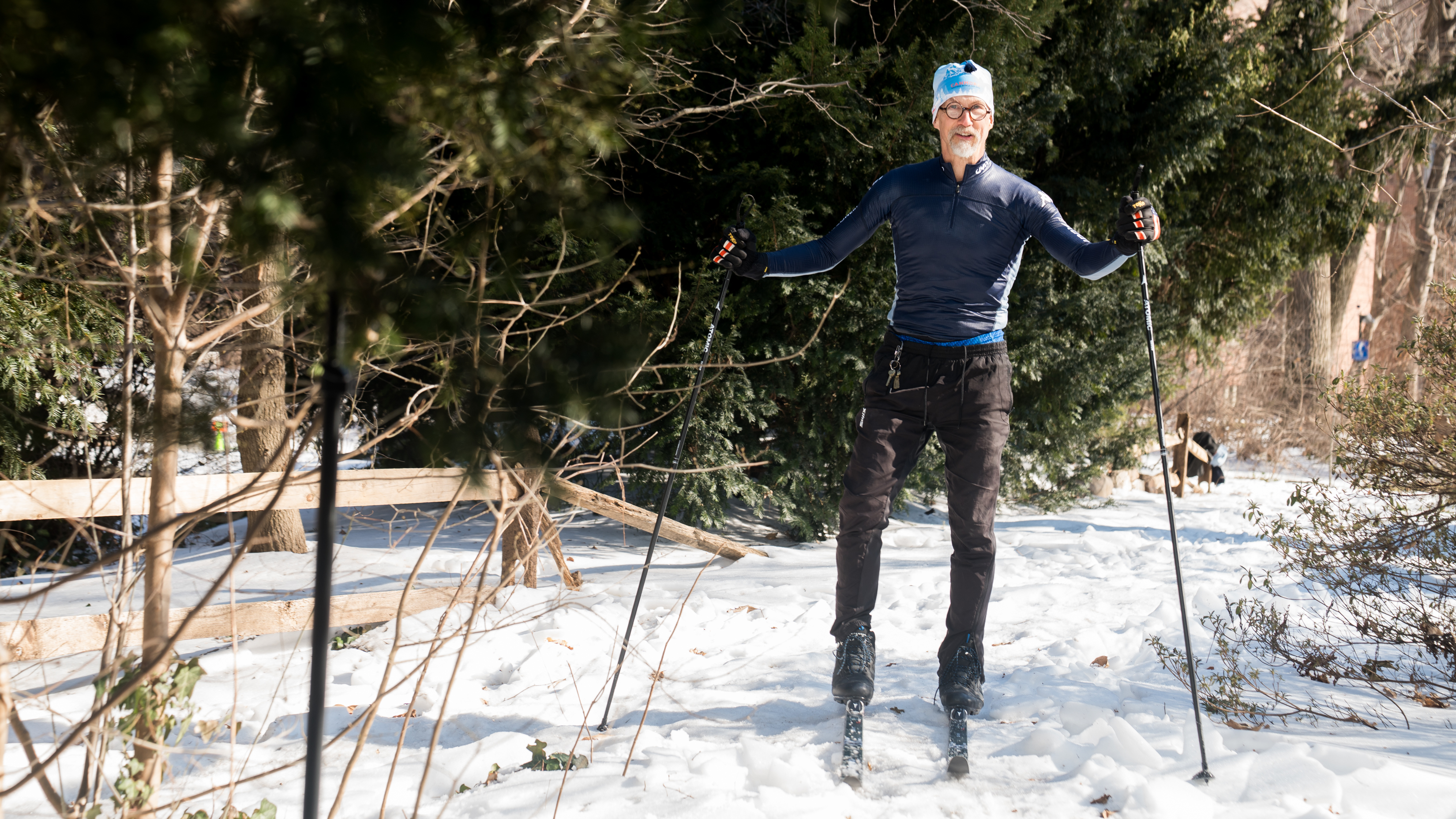 Hansell Stedman stands on cross-country skis on a snowy path