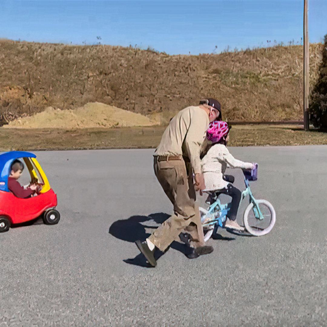 Walter Styer teaching a great-granddaughter to ride a bike