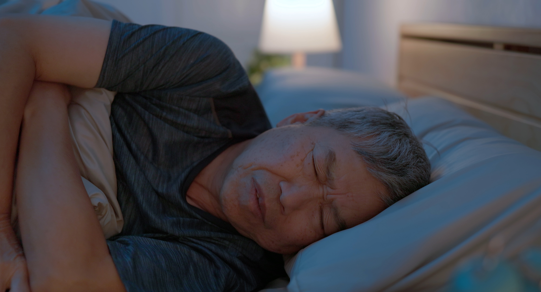 Older man sleeping fitfully