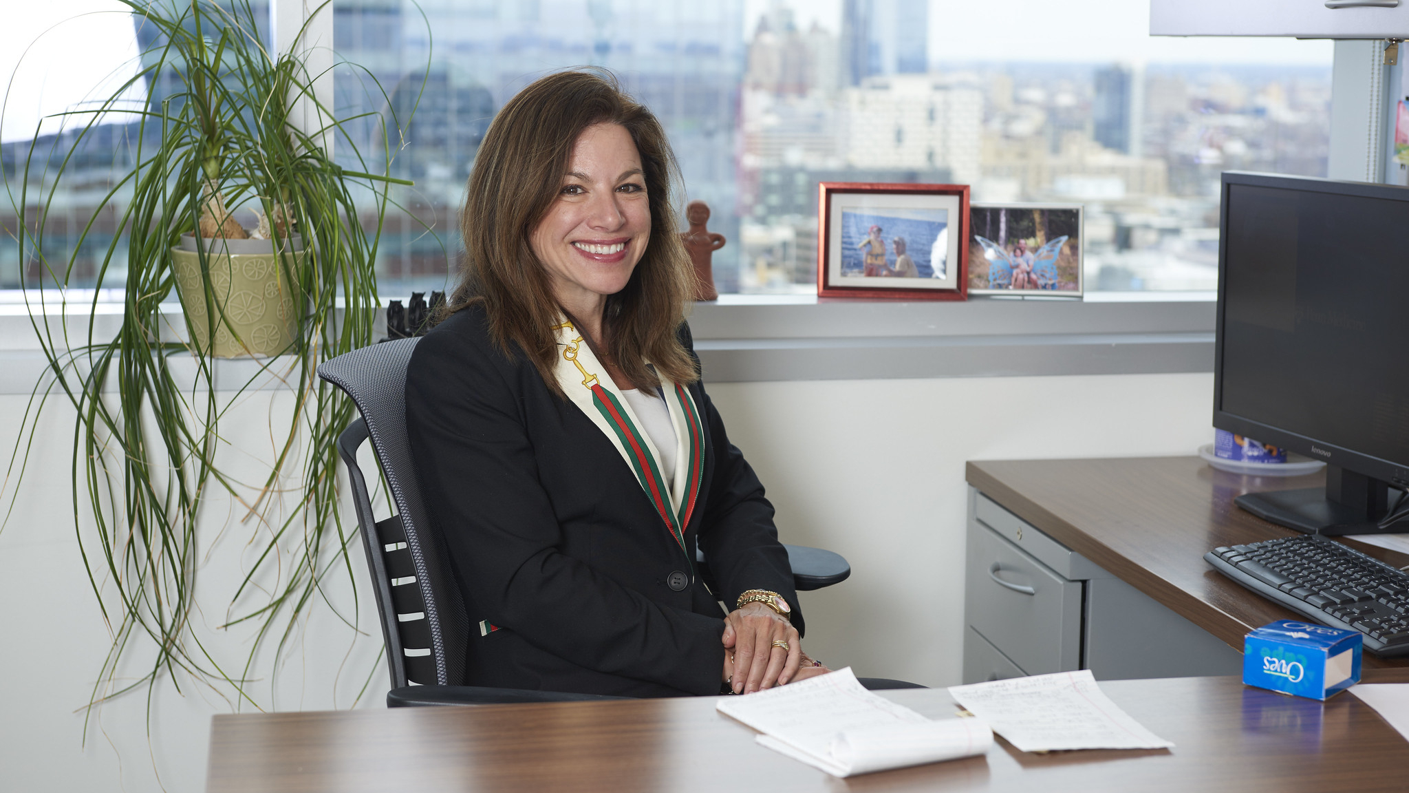 Courtney Schreiber, MD, MPH, seated at a desk in an office