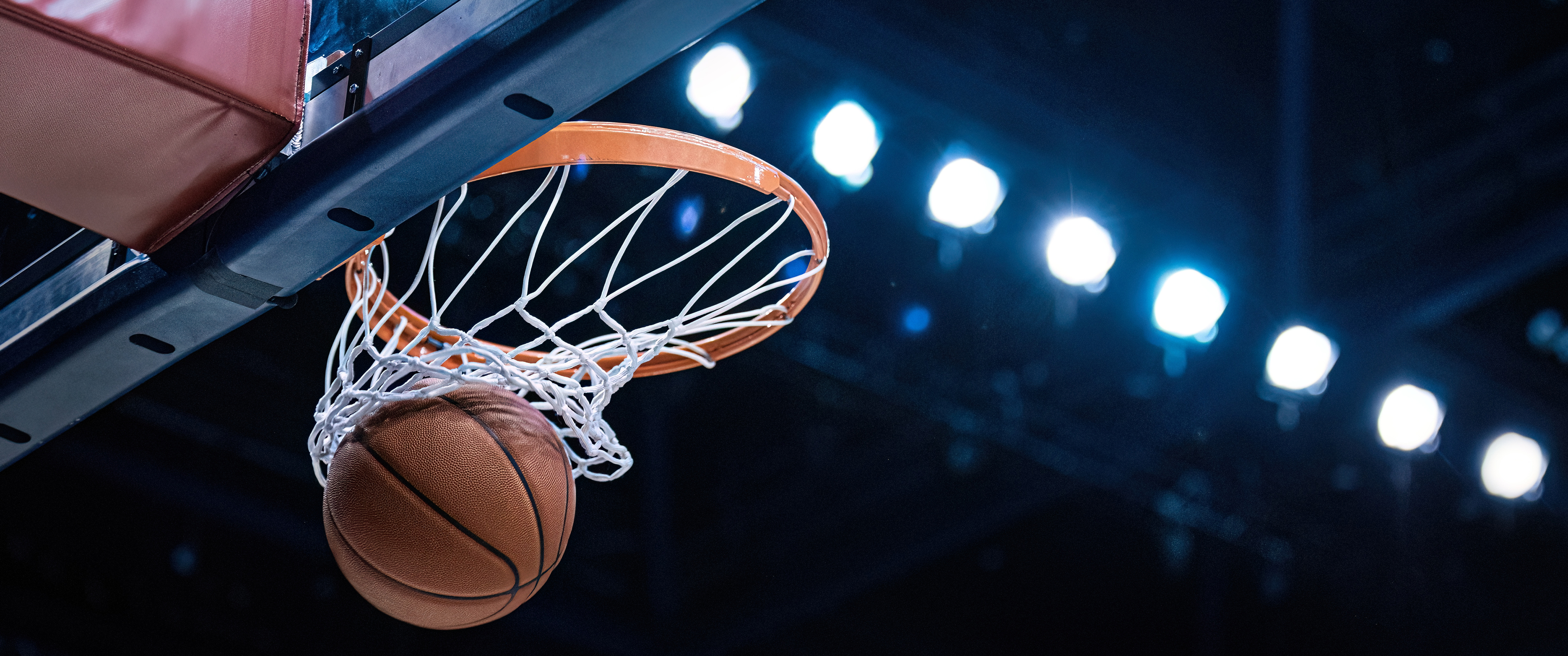 A basketball goes through a basketball net
