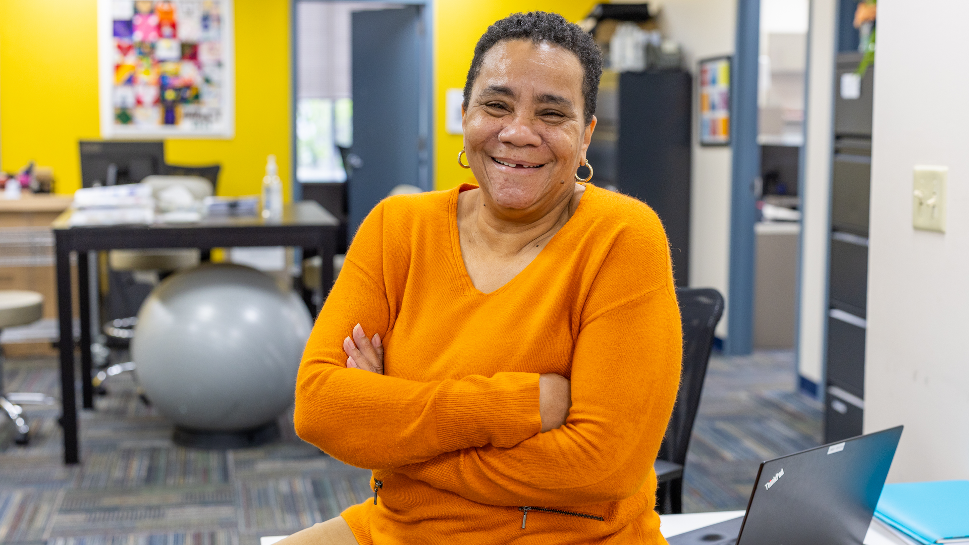 Norma Gerald, with a warm smile and arms crossed