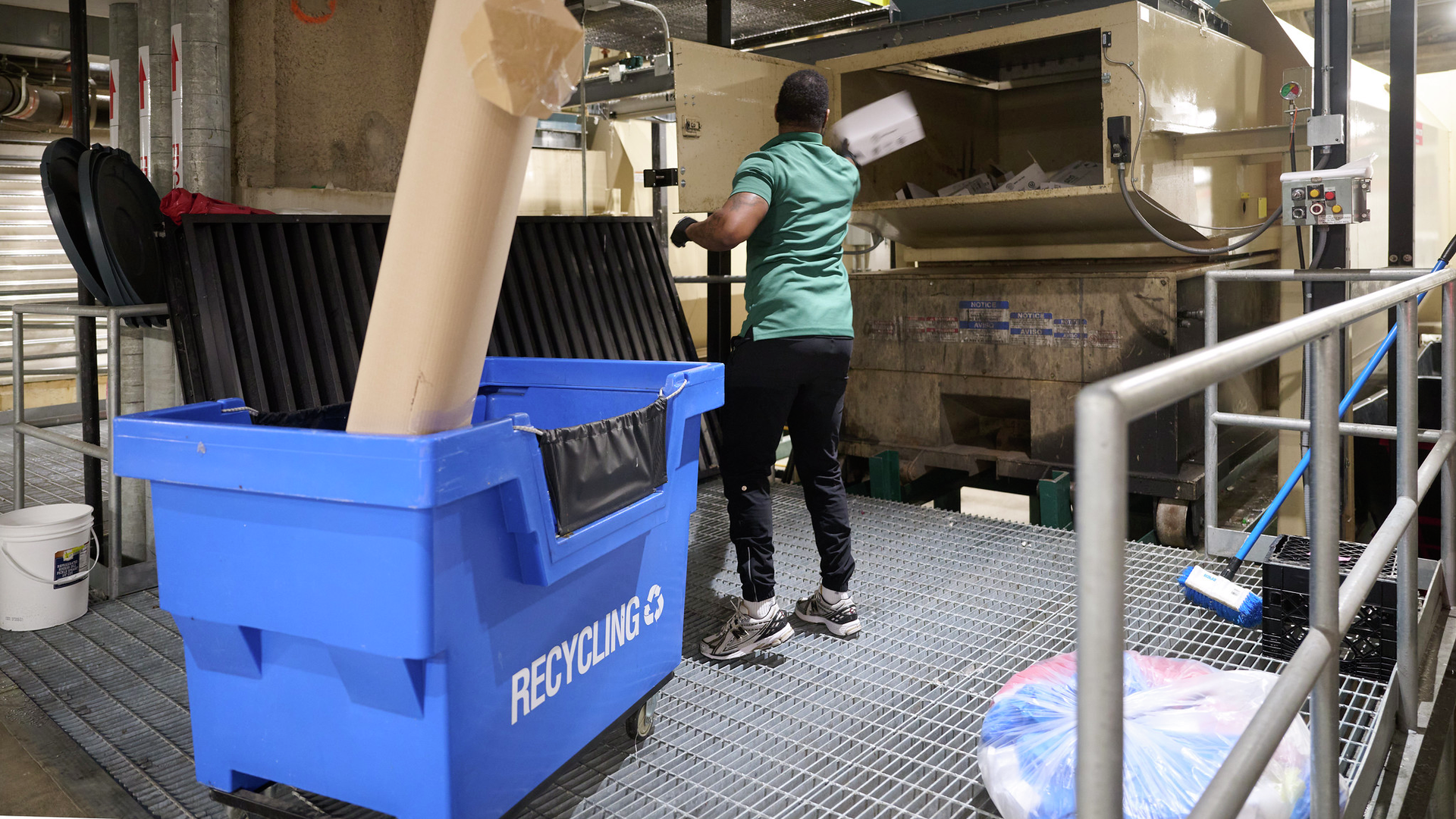 Male employee recycling materials at the Hospital of the University of Pennsylvania recycling facility