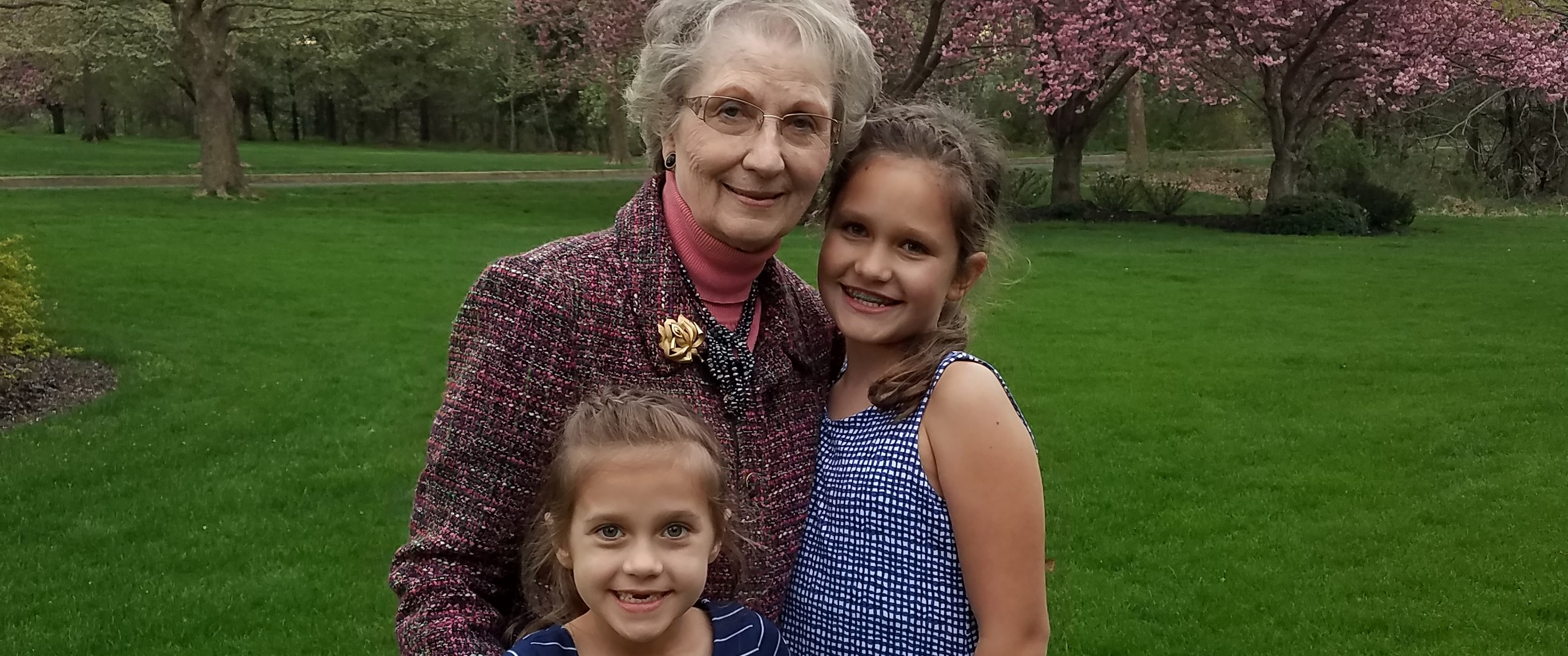 Patient Dalia Jakas stands outside with her two school-aged granddaughters