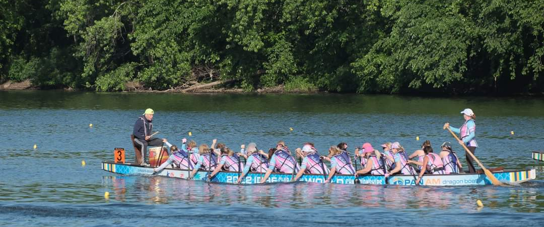 Paddlers rowing in a dragon boat.