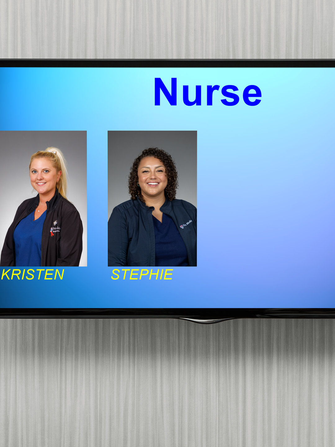A screen mounted on a wall displays the names, job roles, and photos of two nurses